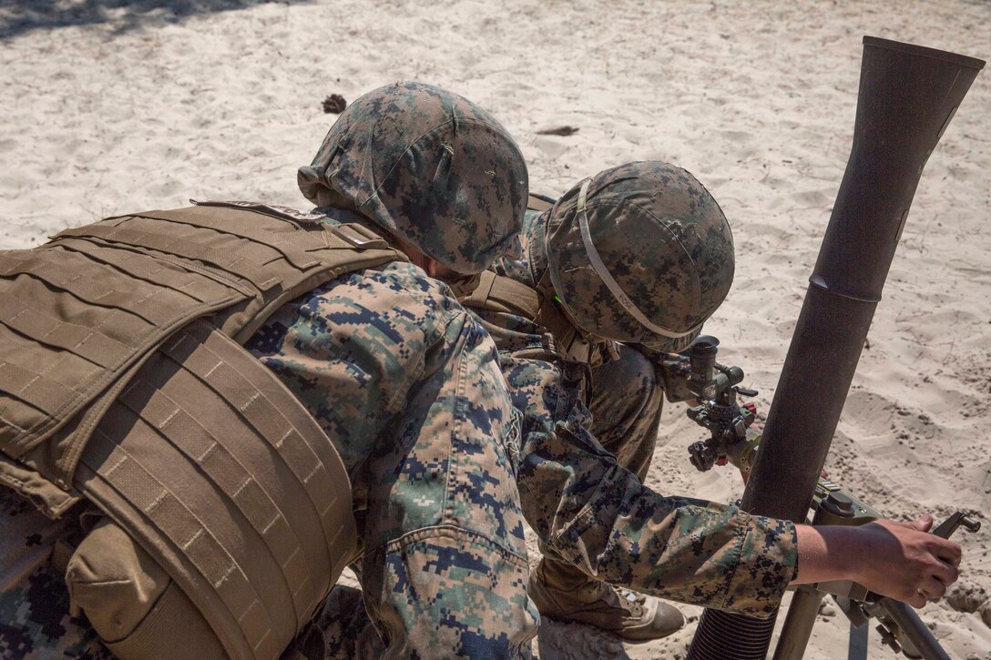 Marines adjust an M252 mortar system to the proper position before a fire mission during exercise Burmese Chase at Camp Lejeune, N.C., May 16, 2017. Marine Corps photo by Pfc. Taylor W. Cooper