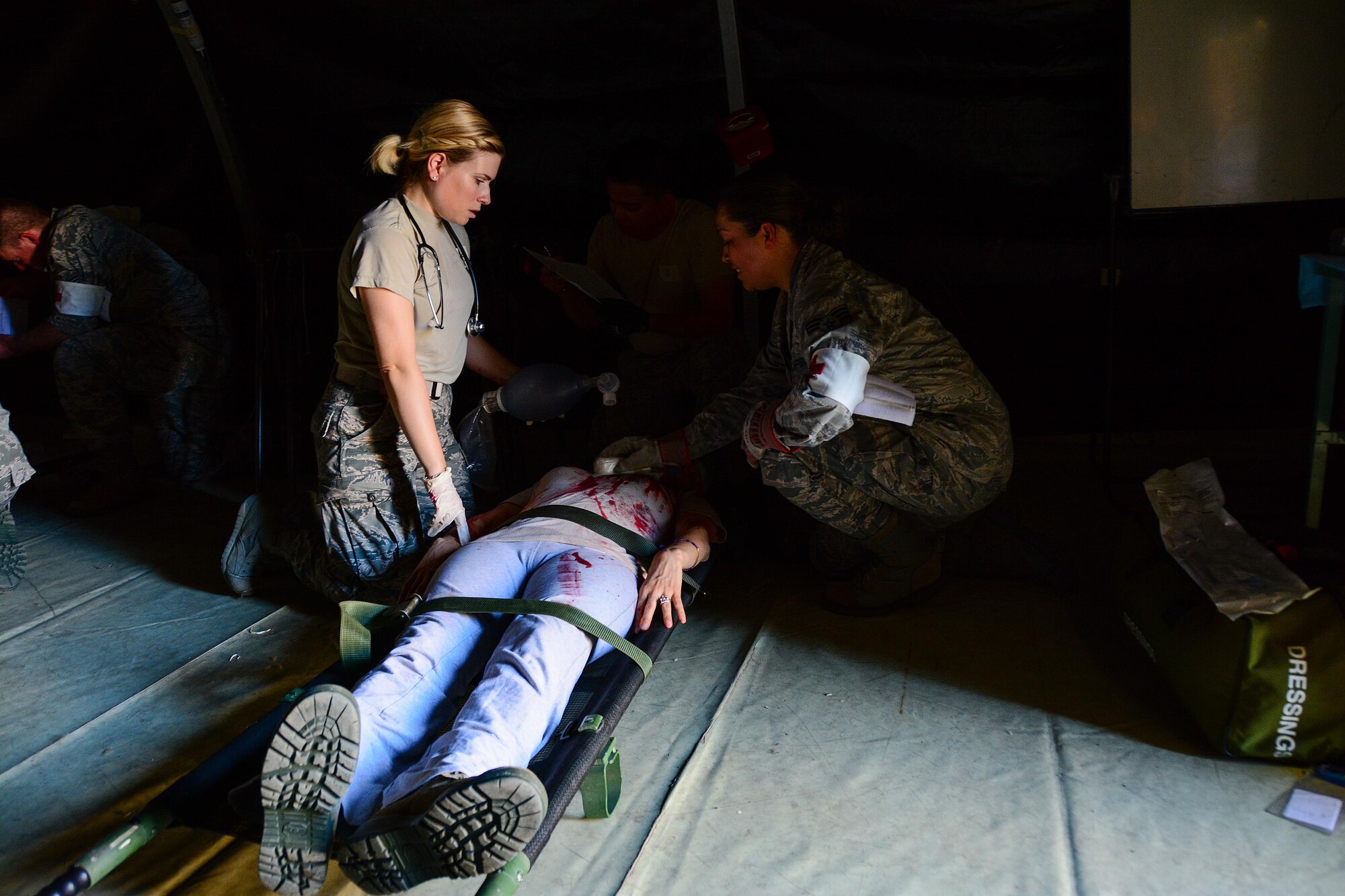 Senior Airman Athena Lebaron-More, 349th Aeromedical Squadron medical technician, treats a patient during a power outage scenario that occured in the middle of a mass casualty exercise at Travis Air Force Base, Calif., on May 19, 2017. The 349th Medical Group conducted a week-long course for medical Airmen from the 349th and 129th MDGs that culminated in a mass casualty exercise. (U.S. Air Force photo/Staff Sgt. Daniel Phelps)