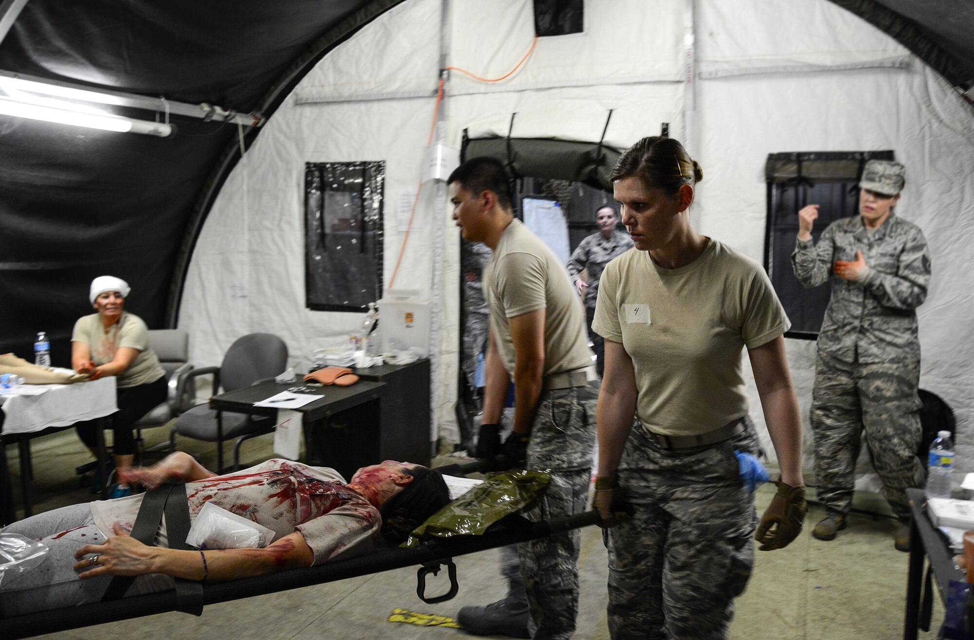 Staff Sgt. Cari Snyder, 349th Aeromedical Squadron medical technician, helps carry a litter during a mass casualty exercise at Travis Air Force Base, Calif., on May 19, 2017. The 349th Medical Group conducted a week-long course for medical Airmen from the 349th and 129th MDGs that culminated in a mass casualty exercise.  (U.S. Air Force photo/Staff Sgt. Daniel Phelps)