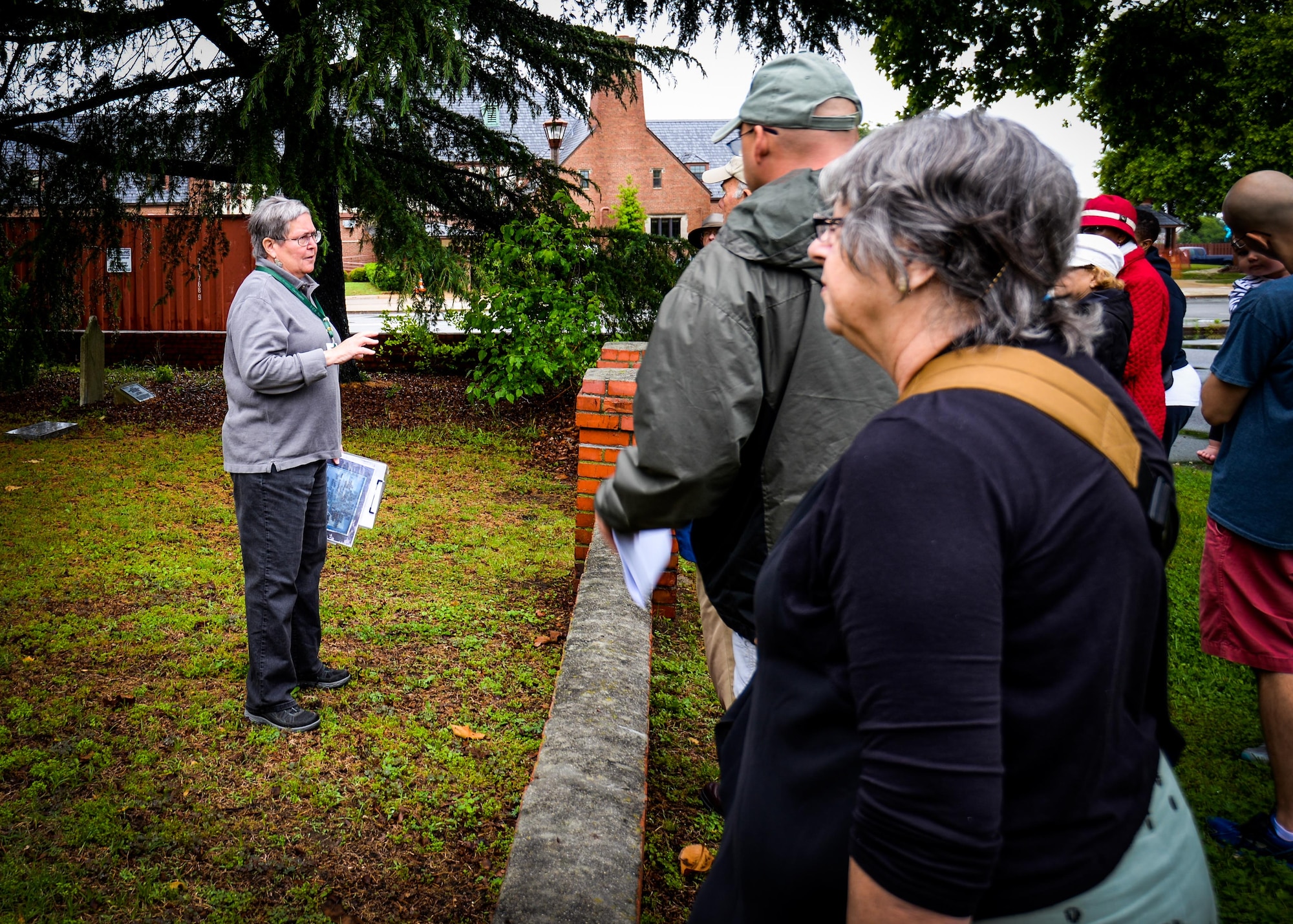 (Left) Carol King, Hampton master tree steward, discusses tree species and land usage history during the Hampton Clean City Commission’s Spring Tree Tour at Joint Base Langley-Eustis, Va., May 13, 2017. This site was home to the Sherwood Plantation in the 1800’s, and although the base acquired the land, the family graves have been cared for as a part of routine base infrastructure management. The Deodar Cedar, one of the trees on the tour, now provides shade to the graveyard at its base. (U.S. Air Force photo/Alicia Garcia)