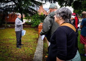 (Left) Carol King, Hampton master tree steward, discusses tree species and land usage history during the Hampton Clean City Commission’s Spring Tree Tour at Joint Base Langley-Eustis, Va., May 13, 2017. This site was home to the Sherwood Plantation in the 1800’s, and although the base acquired the land, the family graves have been cared for as a part of routine base infrastructure management. The Deodar Cedar, one of the trees on the tour, now provides shade to the graveyard at its base. (U.S. Air Force photo/Alicia Garcia)