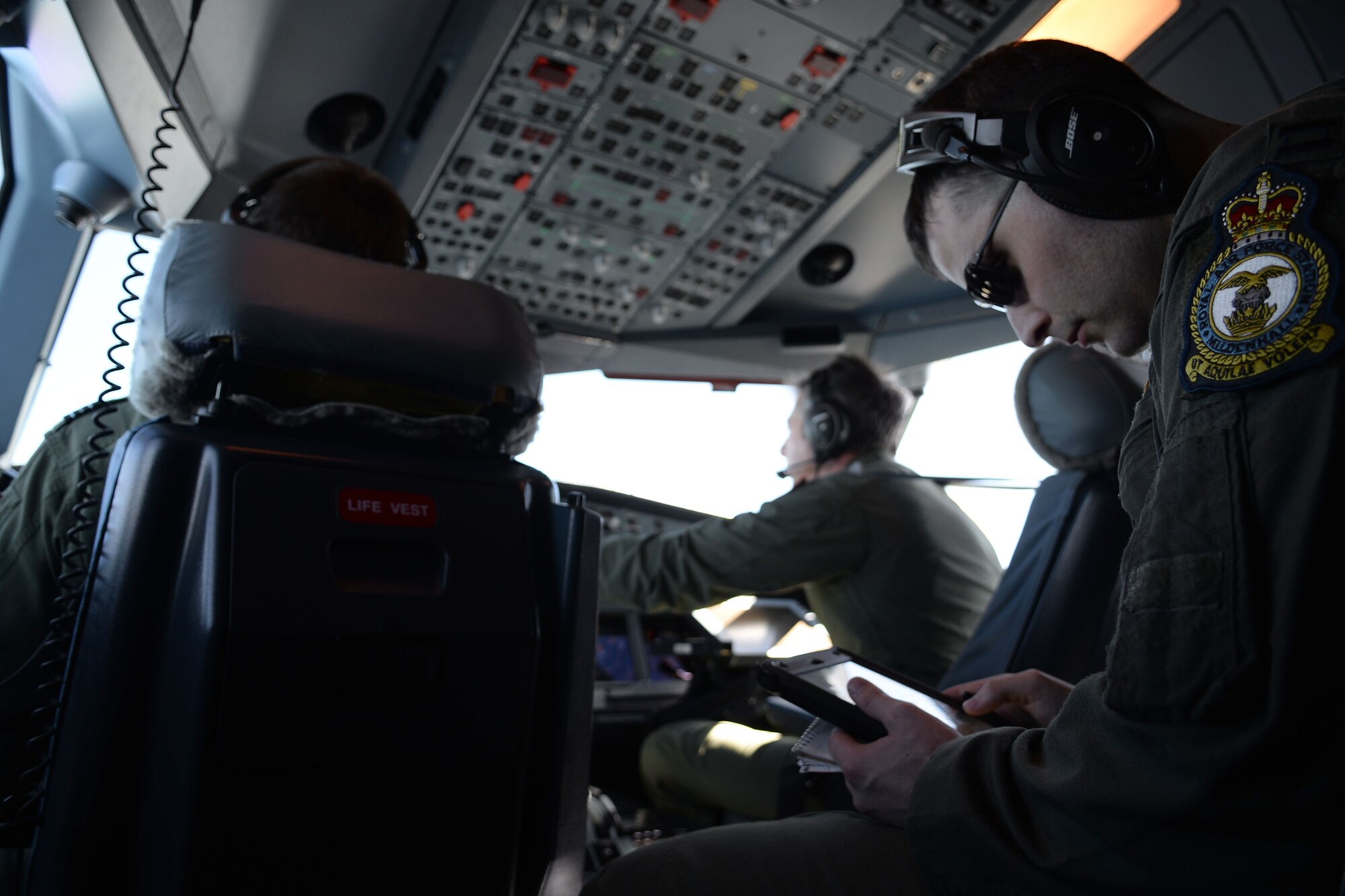 U.S. Air Force Capt. Patrick McGrew, 100th Operations Support Squadron tactics flight commander, studies the path of the Royal Air Force A330 Voyager during the European Tanker Symposium May 11, 2017, over England. The symposium included the Royal Air Force A330 Voyager following the path of a U.S. Air Force KC-135 Strotanker after both aircraft took off from RAF Mildenhall, England. (U.S. Air Force photo by Airman 1st Class Luke Milano)