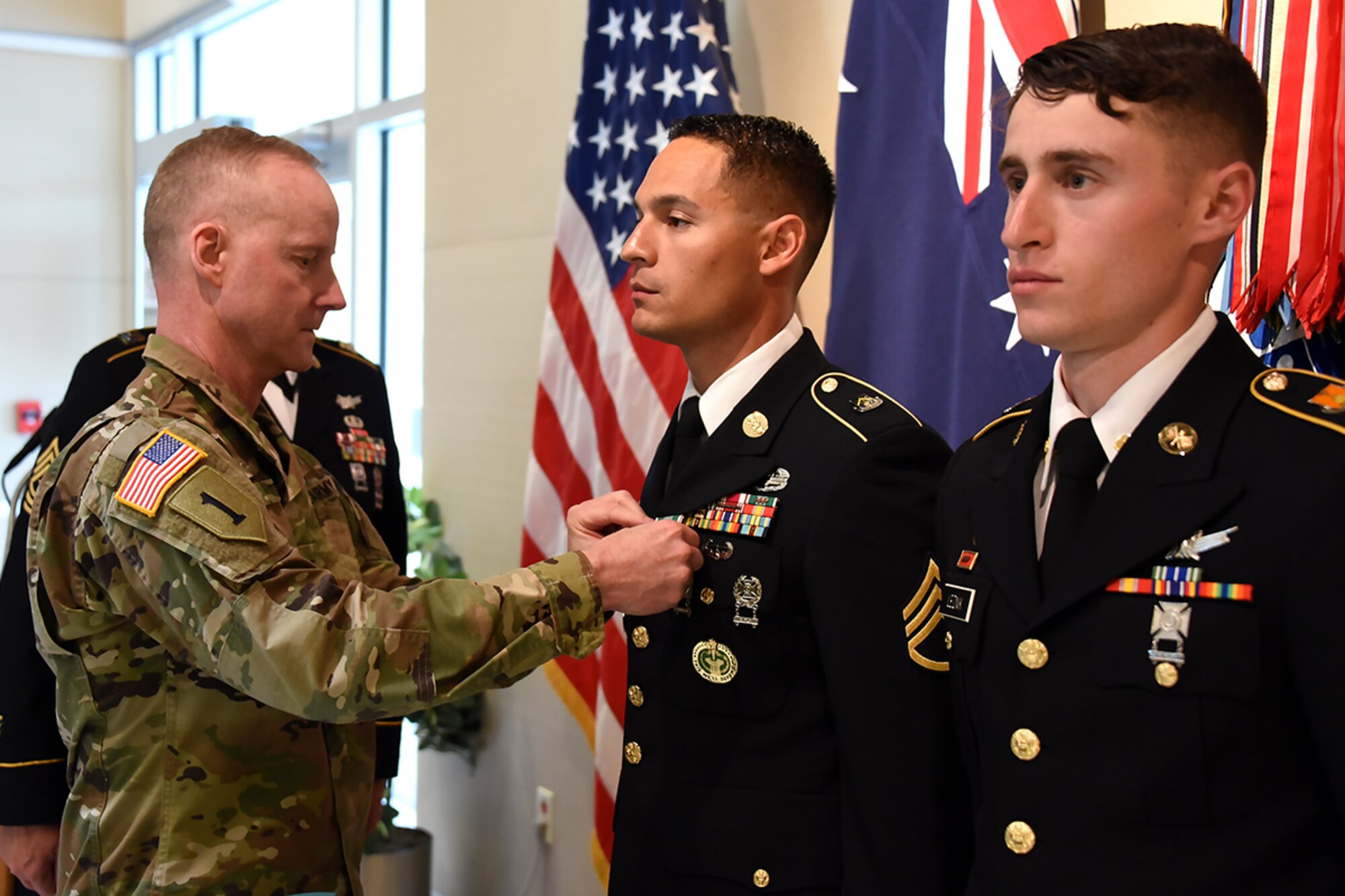 PETERSON AIR FORCE BASE, Colo. - Col. Tim Lawson, deputy commander for support, U.S. Army Space and Missile Defense Command/Army Forces Strategic Command, presents Army Commendation Medals to Staff Sgt. Christian Budeshefsky, SMDC’s 2017 Noncommissioned Officer Best Warrior, and Spc. Samuel Leznik, SMDC’s 2017 Soldier Best Warrior, during a ceremony at the command’s Peterson Air Force Base, Colorado, Operations headquarters, May 11.