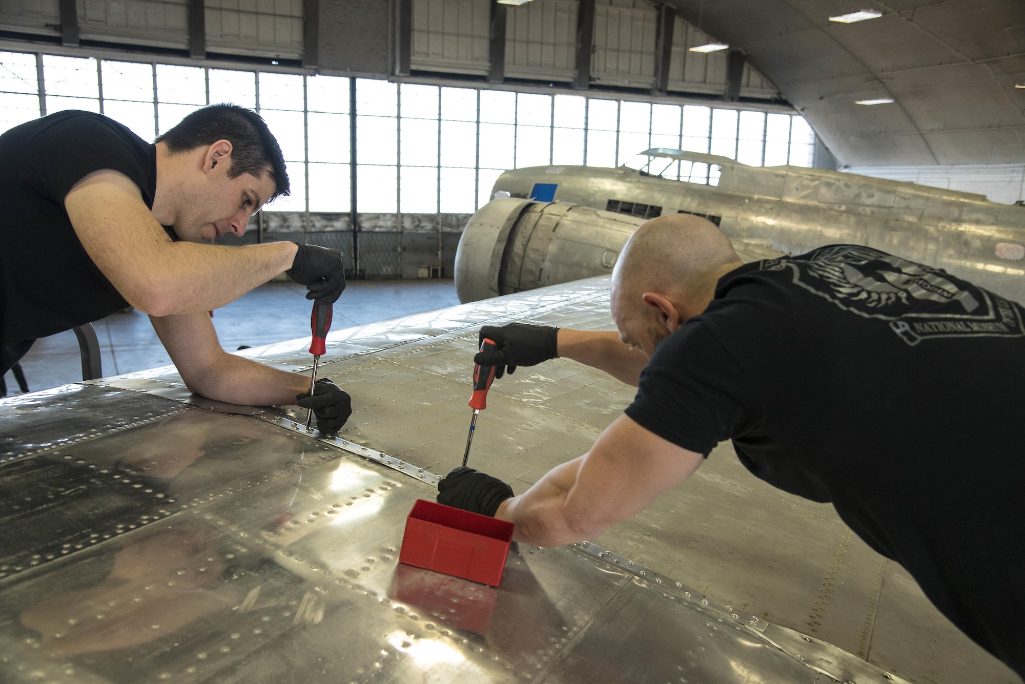 DAYTON, Ohio -- (From left to right) National Museum of the U.S. Air Force restoration specialists Casey Simmons and Chase Meredith install the final wing-tip on the Boeing B-17F Memphis Belle™ on March 22, 2017. The famed B-17F Memphis Belle™ and its crew became iconic symbols of the heavy bomber crews and support personnel who helped defeat Nazi Germany. The Memphis Belle was the first US Army Air Forces heavy bomber to return to the US after completing 25 combat missions over Europe. The USAAF chose the Memphis Belle for a highly-publicized war bond tour from June-August 1943, and its crew was celebrated as national heroes. The aircraft and crew were also the subject of two widely-seen Hollywood movies (one in 1944 and another in 1990). The Memphis Belle will be placed on public display at the museum on May 17, 2018. (U.S. Air Force photo by Ken LaRock)