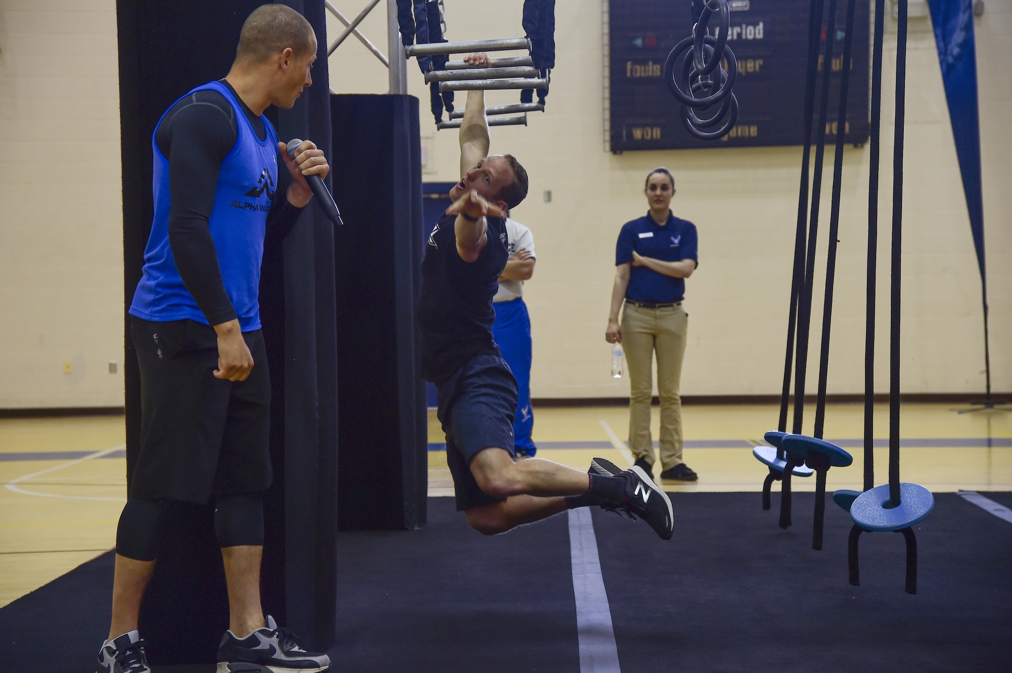 Kevin Klein, an Alpha Warrior professional, demonstrates how to properly use the obstacles before the Alpha Warrior Challenge at Joint Base Langley-Eustis, Va., May 20, 2017. The event held two challenges, one for children and the other for adults.(U.S. Air Force photo/Airman 1st Class Tristan Biese)