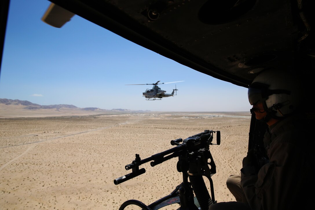 Lance Cpl. Gregory Ybarra, a Marine Light Attack Helicopter Squadron (HMLA) 469 UH-1Y crew chief, stands by to provide cover fire during a tactical recovery of aircraft and personnel (TRAP) training mission for Integrated Training Exercise (ITX) 3-17 at Marine Corps Air Ground Combat Center Twentynine Palms, Calif., May 17. ITX is a combined-arms training exercise enabling Marines across 3rd Marine Aircraft Wing to operate as an aviation combat element integrated with ground and logistics combat elements as a Marine air-ground task force. More than 650 Marines and 27 aircraft with 3rd MAW are supporting ITX 3-17. (U.S. Marine Corps photo by Sgt. David Bickel/Released)