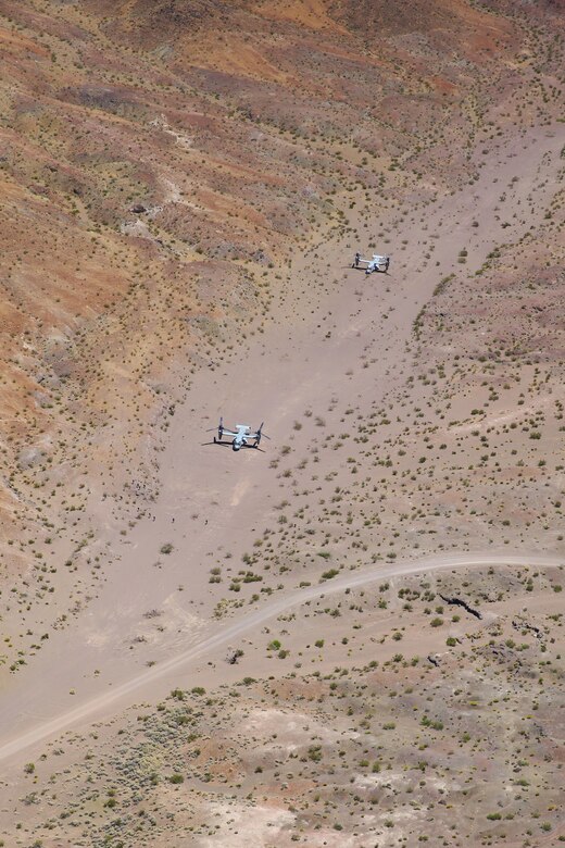 MV-22 Ospreys with Marine Medium Tiltrotor Squadron (VMM) 363 wait as Marines with 3rd Marine Regiment asses a simulated casualty situation during a tactical recovery of aircraft and personnel (TRAP) training mission for Integrated Training Exercise (ITX) 3-17 at Marine Corps Air Ground Combat Center Twentynine Palms, Calif., May 17. ITX is a combined-arms training exercise enabling Marines across 3rd Marine Aircraft Wing to operate as an aviation combat element integrated with ground and logistics combat elements as a Marine air-ground task force. More than 650 Marines and 27 aircraft with 3rd MAW are supporting ITX 3-17. (U.S. Marine Corps photo by Sgt. David Bickel/Released)