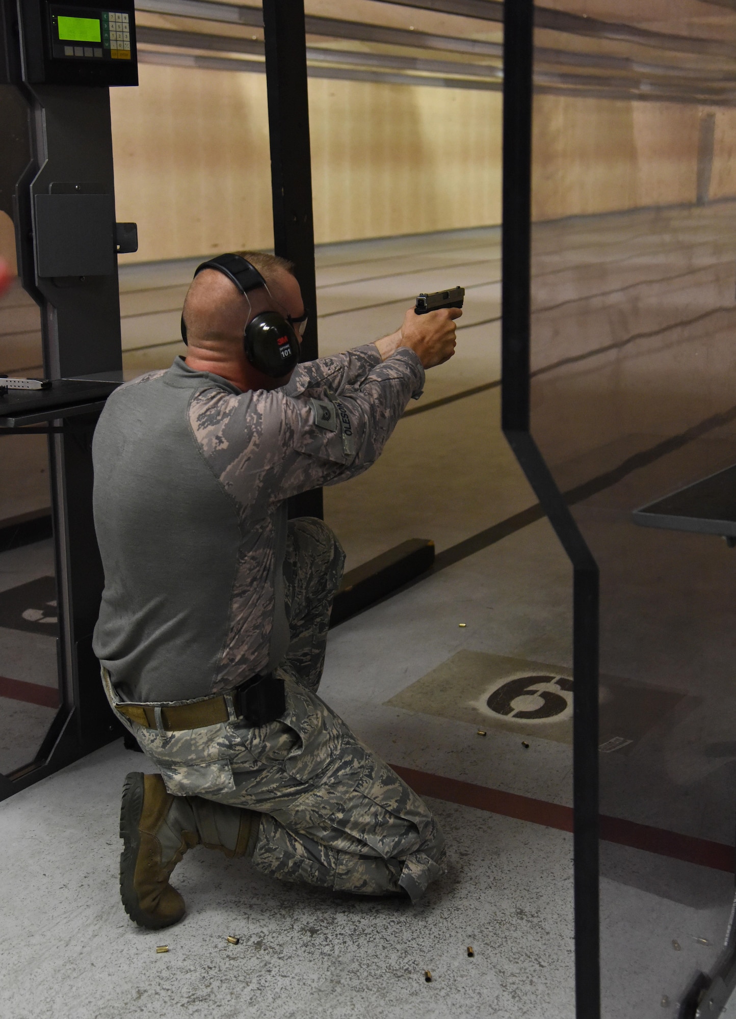 Tech. Sgt. Matthew Oleson, 81st Security Forces Squadron flight chief, fires his weapon during the 81st SFS law enforcement team competition shoot in the indoor firing range May 17, 2017, on Keesler Air Force Base, Miss. The event was held during National Police Week, which recognizes the service of law enforcement men and women who put their lives at risk every day. (U.S. Air Force photo by Kemberly Groue)