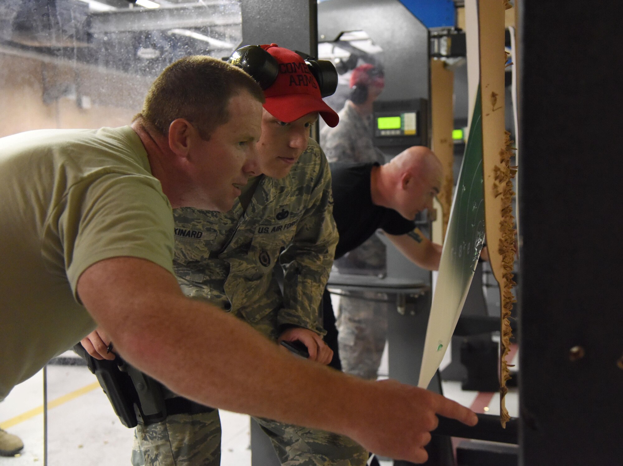 Tech. Sgt. Michael O’Neil, 81st Security Forces Squadron armory NCOIC, calculates his target score with Staff Sgt. Jarrod Kinard, 81st SFS combat arms NCOIC, during the 81st SFS law enforcement team competition shoot in the indoor firing range May 17, 2017, on Keesler Air Force Base, Miss. The event was held during National Police Week, which recognizes the service of law enforcement men and women who put their lives at risk every day. (U.S. Air Force photo by Kemberly Groue)