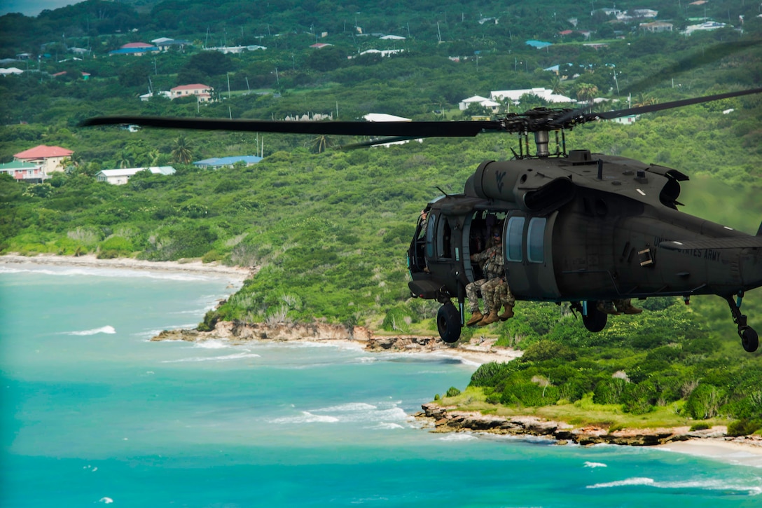 Soldiers fly along the coastline as they assess and area of critical infrastructure in a disaster response scenario to support Operation Vigilant Guard on St. Croix, Virgin Islands, May 16, 2017. The soldiers are assigned to West Virginia Army National Guard's 1st Battalion, 150th Aviation Regiment and 2nd Battalion, 19th Special Forces Group. Army photo by Sgt. Lisa M. Sadler