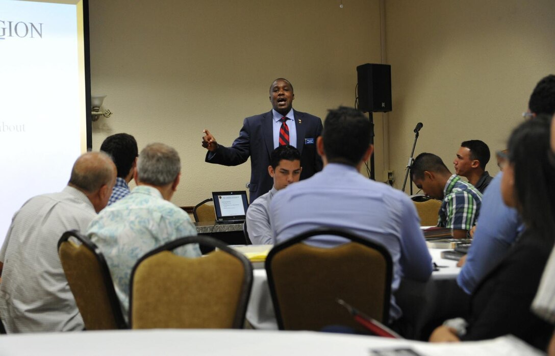 Rodney K. Rolland, director of human resources at The American Legion National Headquarters, explains how to properly prepare a resume during Hiring Our Heroes job fair held at Community Club, on Fort Buchanan, May 18th.