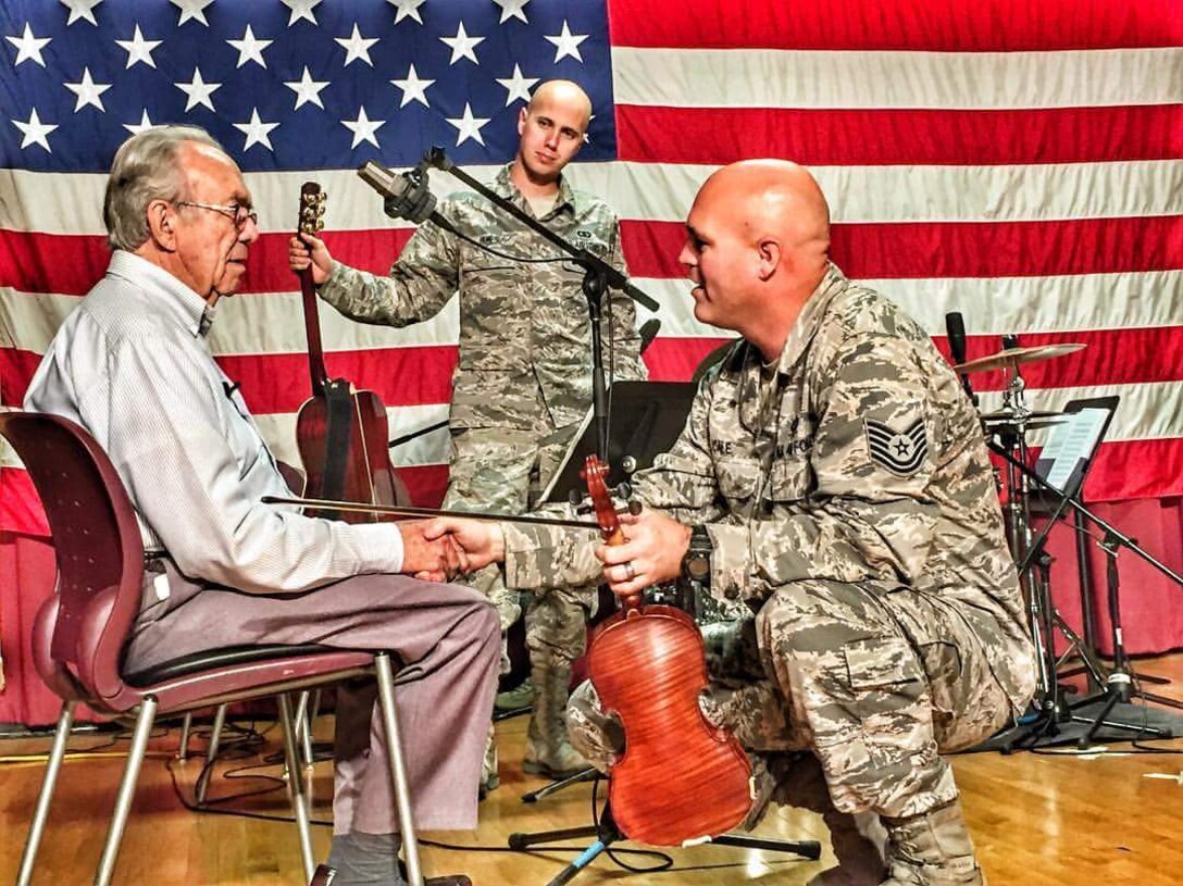 TSgt Jason Cale, a member of the USAF Heritage of America Band's Blue Aces, works with a veteran at the Salem, Virginia Veterans Medical Center.  The band was assisting a board-certified music therapist while on a 4-day mission to the center.