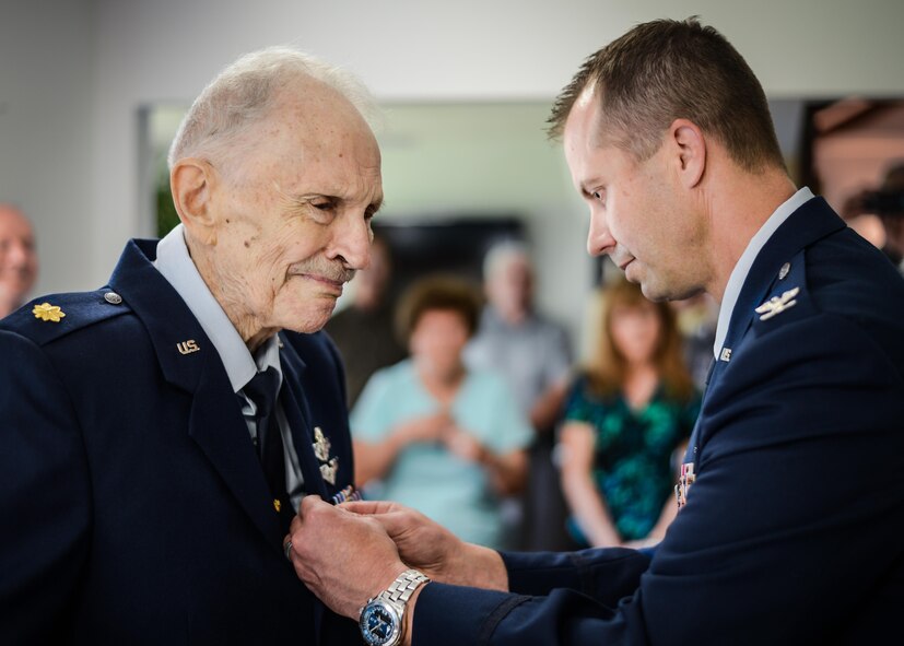 Retired Maj. Joe Campbell is awarded the Distinguished Flying Cross by Col. Ty Neuman, 2nd Bomb Wing commander, during an award ceremony at his residence in Shreveport, La., May 18, 2017. Campbell, a veteran of World War II, the Korean War, and Vietnam, received the award for heroism and extraordinary achievement during aerial operations in the Korean War. (U.S. Air Force photo/Senior Airman Mozer O. Da Cunha)