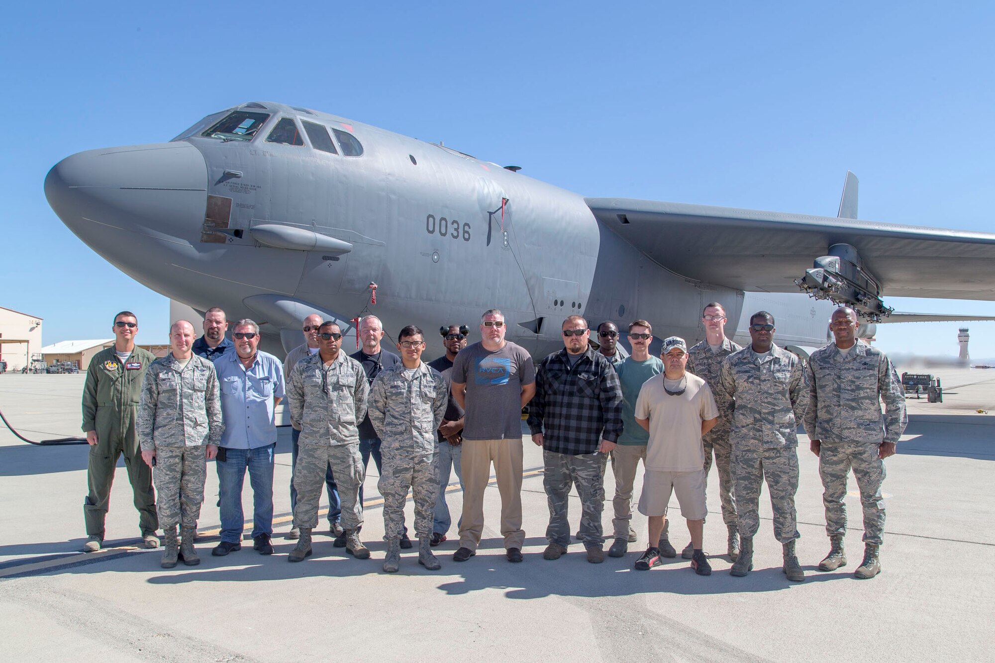 Brig. Gen. Carl E. Schaefer (second from left), 412th Test Wing commander, poses for a group photo after presenting challenge coins to 912th Aircraft Maintenance Squadron personnel on behalf of Gen. Ellen M. Pawlikowski, commander of Air Force Materiel Command. Pawlikowski issued the coins as thanks for efforts undertaken to make her flight possible aboard a B-52 Stratofortress during a sortie earlier in May. (U.S. Air Force photo by Christopher Okula)