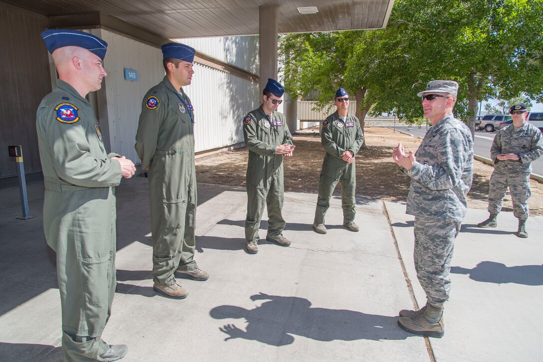 Pictured from left to right: Capt. Stephen Gray, Capt. James McDonald, Maj. Josh Strafaccia and Lt. Col. Miles T. Middleton, speak with Brig. Gen. Carl Schaefer (far right), 412th Test Wing commander, after he  presented challenge coins on behalf of Gen. Ellen M. Pawlikowski, commander of Air Force Materiel Command. Pawlikowski issued the coins as a thanks for efforts undertaken to make her flight possible aboard a B-52 Stratofortress during a sortie earlier this month. The bomber and crew are from the 419th Flight Test Squadron. (U.S. Air Force photo by Christopher Okula)
