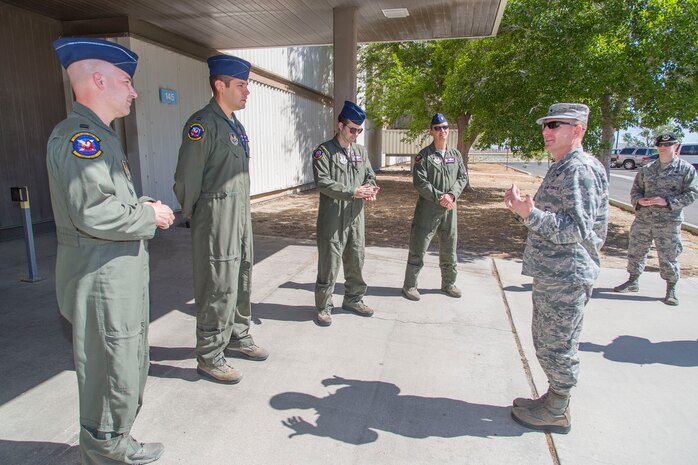 Pictured from left to right: Capt. Stephen Gray, Capt. James McDonald, Maj. Josh Strafaccia and Lt. Col. Miles T. Middleton, speak with Brig. Gen. Carl Schaefer (far right), 412th Test Wing commander, after he  presented challenge coins on behalf of Gen. Ellen M. Pawlikowski, commander of Air Force Materiel Command. Pawlikowski issued the coins as a thanks for efforts undertaken to make her flight possible aboard a B-52 Stratofortress during a sortie earlier this month. The bomber and crew are from the 419th Flight Test Squadron. (U.S. Air Force photo by Christopher Okula)
