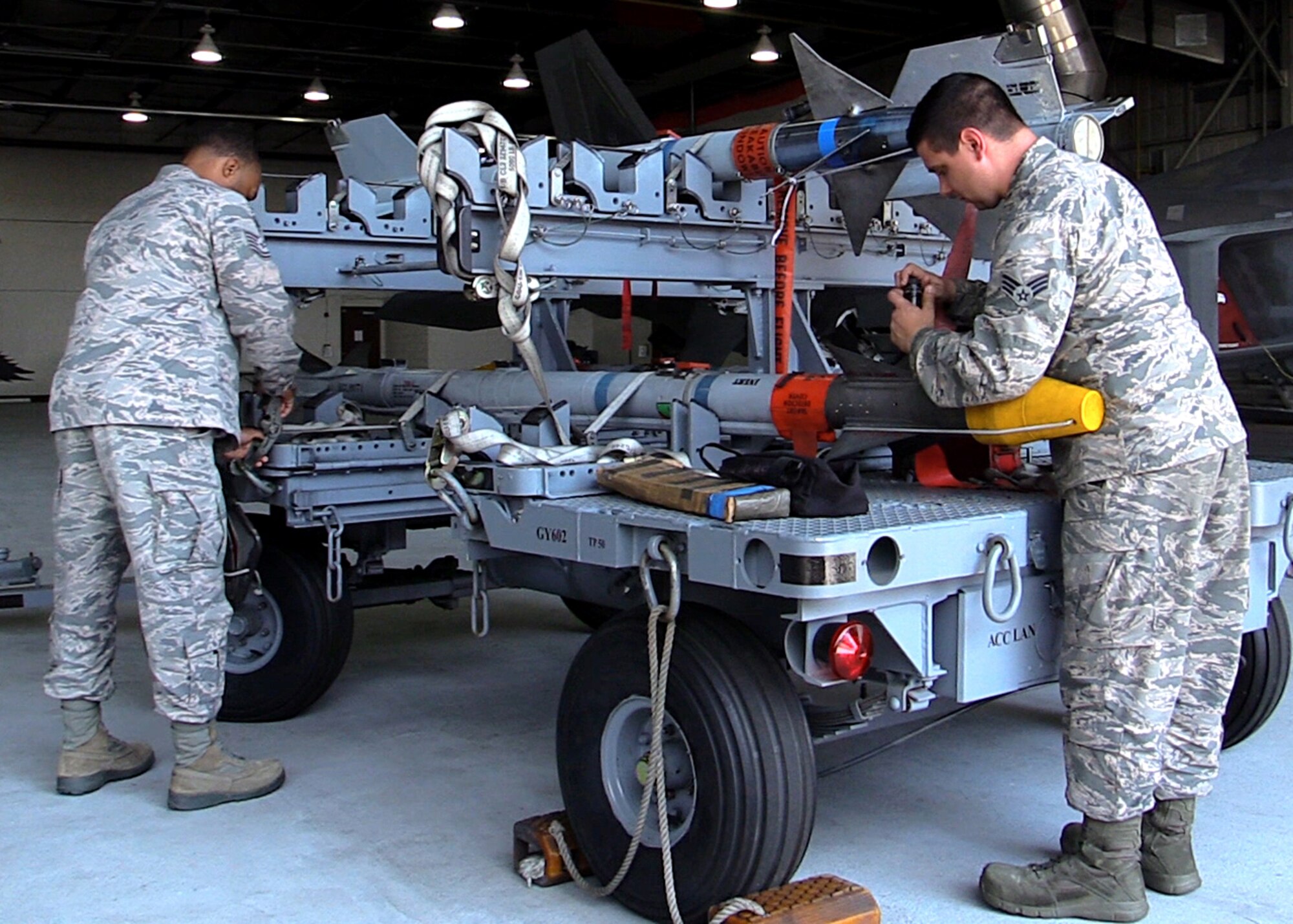 U.S. Air Force Tech. Sgt. Joshua Patterson, 1st Maintenance Group weapons standardization lead crew member, and U.S. Air Force Senior Airman Russell Taylor, 1st Maintenance Group weapons standardization lead crew member, does checks on an AIM-9X missile before being loaded onto an F-22 Raptor, at Joint Base Langley-Eustis, Va., April 19, 2017. Before the AIM-9X, the F-22 had the AIM-9M which dates back to the Vietnam War. (U.S. Air Force photo/Airman 1st Class Amanda Dole)