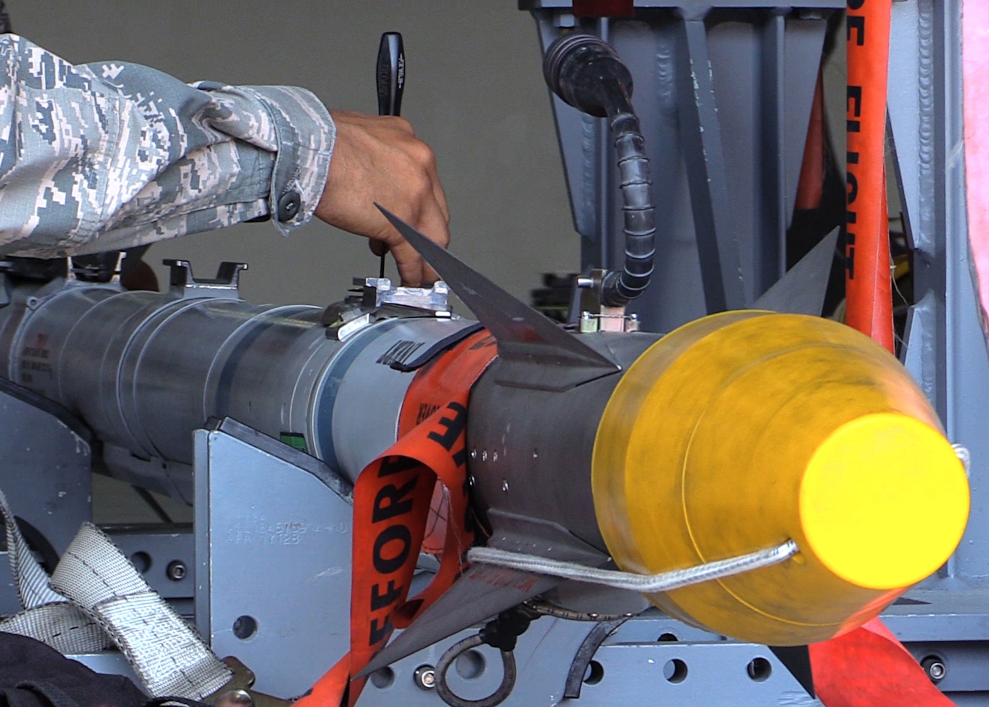 U.S. Air Force Senior Airman Christopher Lewis, 1st Maintenance Group weapons standardization lead crew member, prepares an AIM-9X missile to be loaded onto an F-22 Raptor, at Joint Base Langley-Eustis, Va., April 19, 2017. Compared to the older AIM-9M, the AIM-9X maneuvers easier, picks up heat signatures better and is a safer weapon overall. (U.S. Air Force photo/Airman 1st Class Amanda Dole)