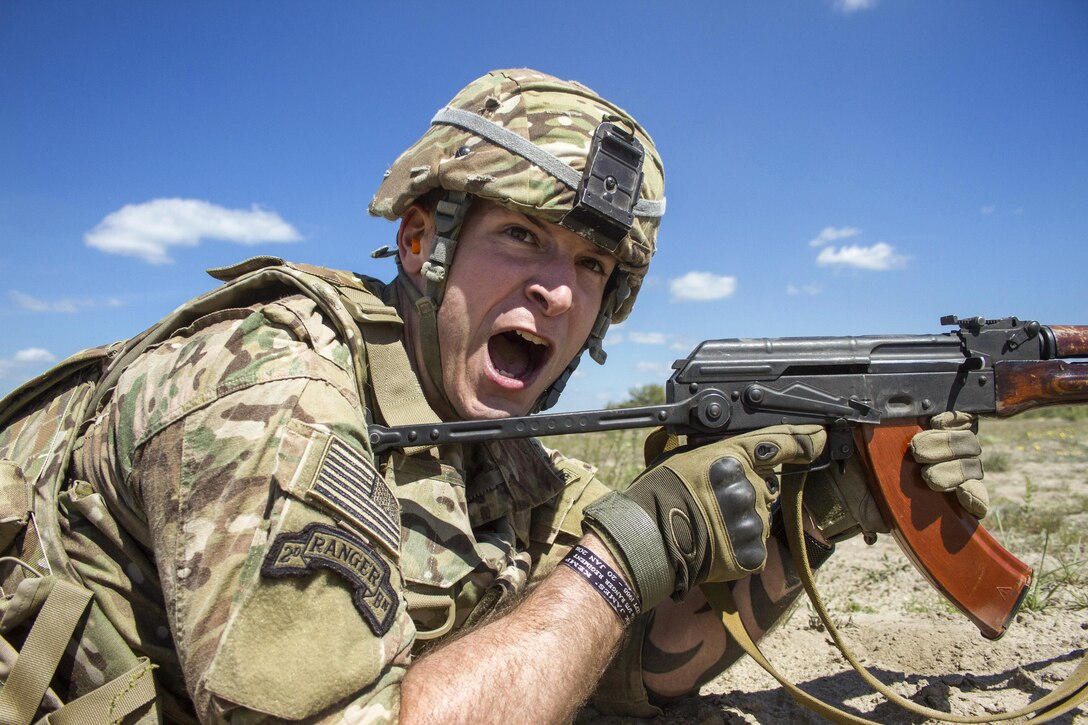 Army Sgt. Matthew Councill shouts commands to his team of Canadian soldiers during a U.S.-Canadian demonstration of a section attack for Ukrainian noncommissioned officers near Zhytomyr, Ukraine, May 22, 2017. Councill is assigned to the Joint Multinational Training Group Ukraine. Army photo by Sgt. Anthony Jones