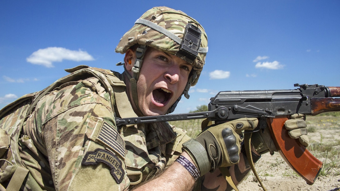 Army Sgt. Matthew Councill shouts commands to his team of Canadian soldiers during a U.S.-Canadian demonstration of a section attack for Ukrainian noncommissioned officers near Zhytomyr, Ukraine, May 22, 2017. Councill is assigned to the Joint Multinational Training Group Ukraine. Army photo by Sgt. Anthony Jones