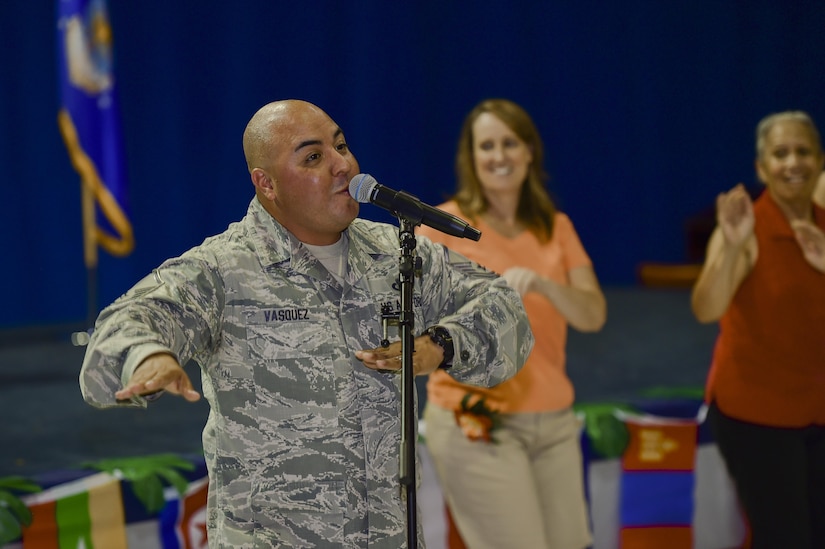 U.S. Air Force Master Sgt. Richard Vasquez, U.S. Air Force Heritage of America Band vocalist, sings and dances with members of the audience during the Asian American and Pacific Islander Heritage Month Ceremony at Joint Base Langley-Eustis, Va., May 16, 2017. In 1992, May was designated as Asian American and Pacific Islander Heritage Month to recognize the important contributions they have made to society. (U.S. Air Force photo/Airman 1st Class Tristan Biese)