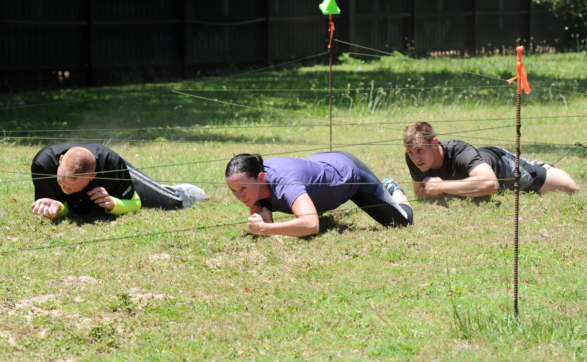 81st Medical Operations Squadron Team 2 members participate in the low crawl portion during the 81st Security Forces Squadron obstacle course competition May 16, 2017, on Keesler Air Force Base, Miss. The competition was held during National Police Week, which recognizes the service of law enforcement men and women. (U.S. Air Force photo by Kemberly Groue)