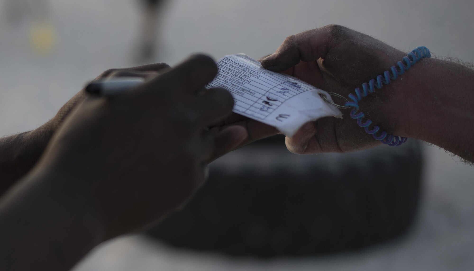 Members of MacDill complete their obstacles by having their team card signed off by a volunteer during the Gladiator Challenge at MacDill Air Force Base, Fla., May 19, 2017. Each team had to get signed off before moving on to the next obstacle. (U.S. Air Force photo by Airman 1st Class Ashley Perdue)