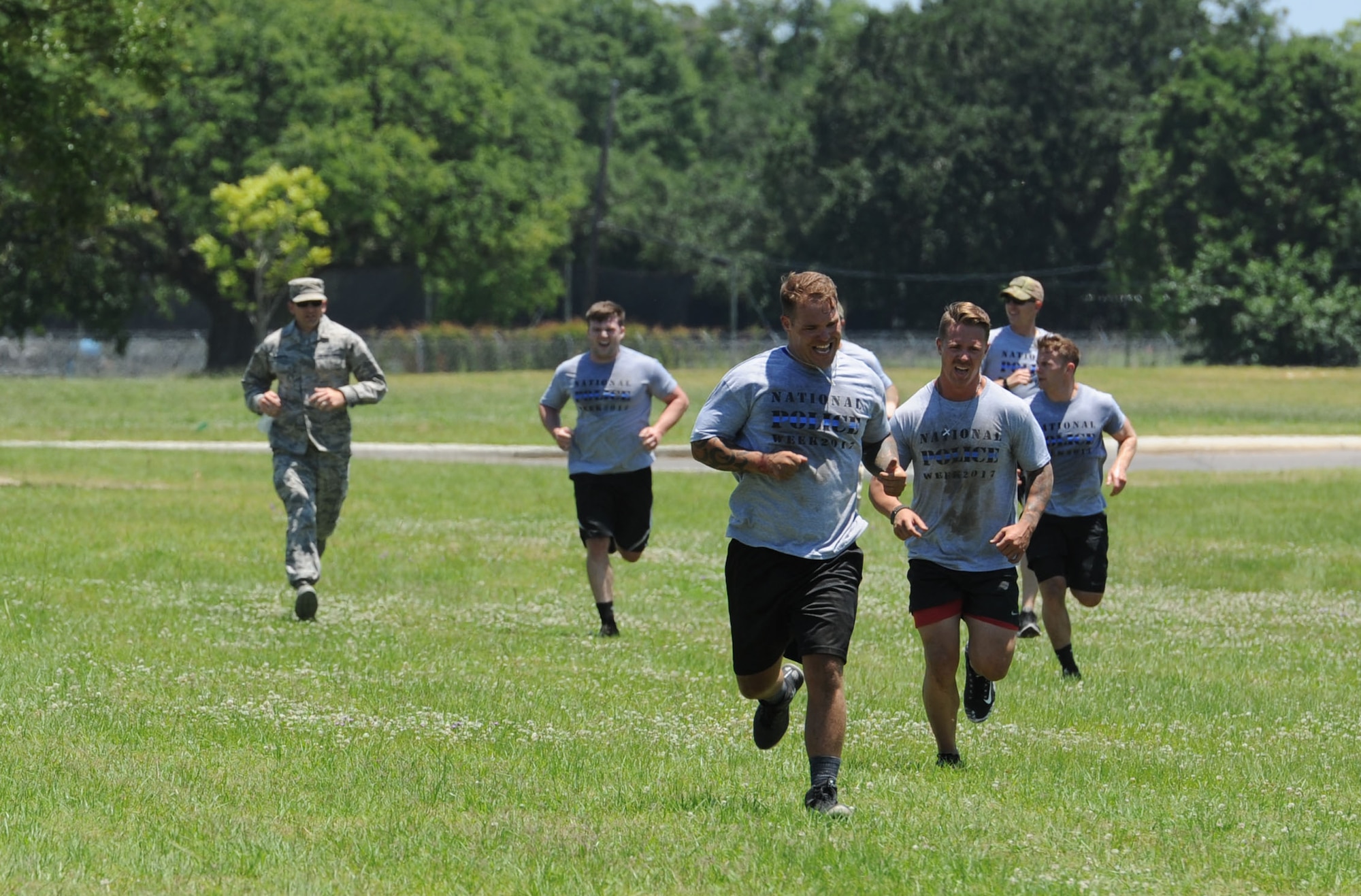 Members of the 81st Security Forces Squadron team run the last leg of the 81st SFS obstacle course competition May 16, 2017, on Keesler Air Force Base, Miss. The competition was held during National Police Week, which recognizes the service of law enforcement men and women. (U.S. Air Force photo by Kemberly Groue)