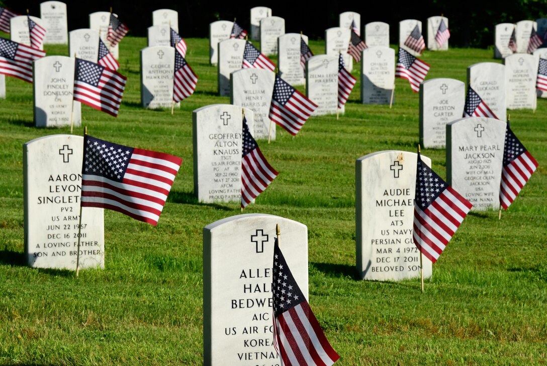 American flags adorn headstones at the Arkansas State Veterans Cemetery following this year's Memorial Day flag placement ceremony conducted by airmen assigned to the  Arkansas National Guard's 189th Airlift Wing in North Little Rock, Ark., May 24, 2017. Army National Guard photo by Spc. Stephen Wright