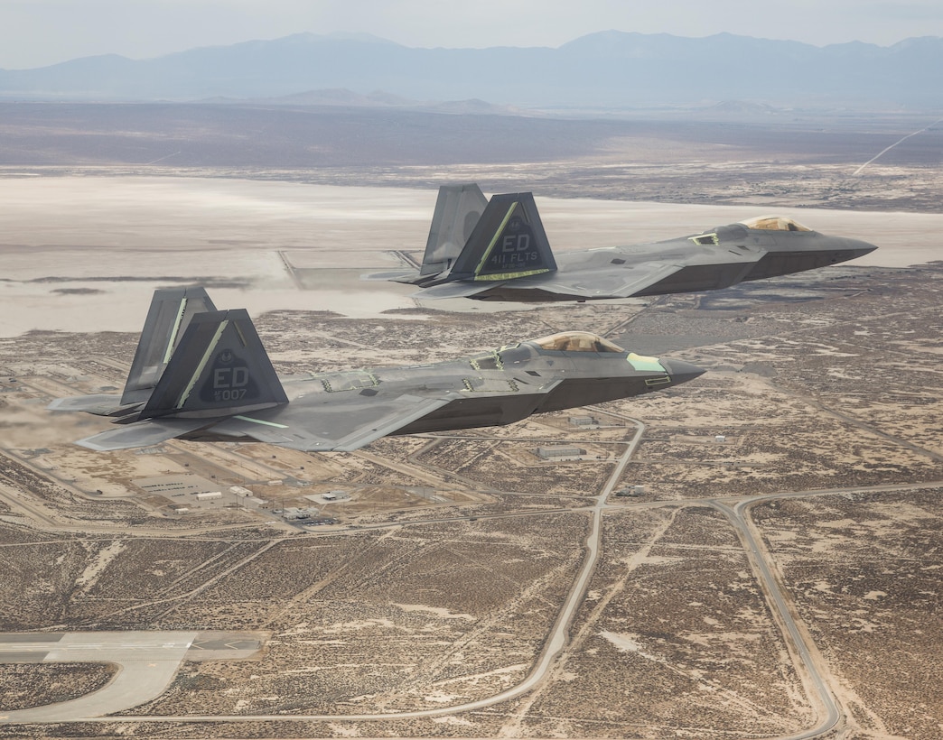 Two F-22 Raptors from the 411th Flight Test Squadron fly over Edwards Air Force Base, California. (Courtesy photo by Chad Bellay/Lockheed Martin)