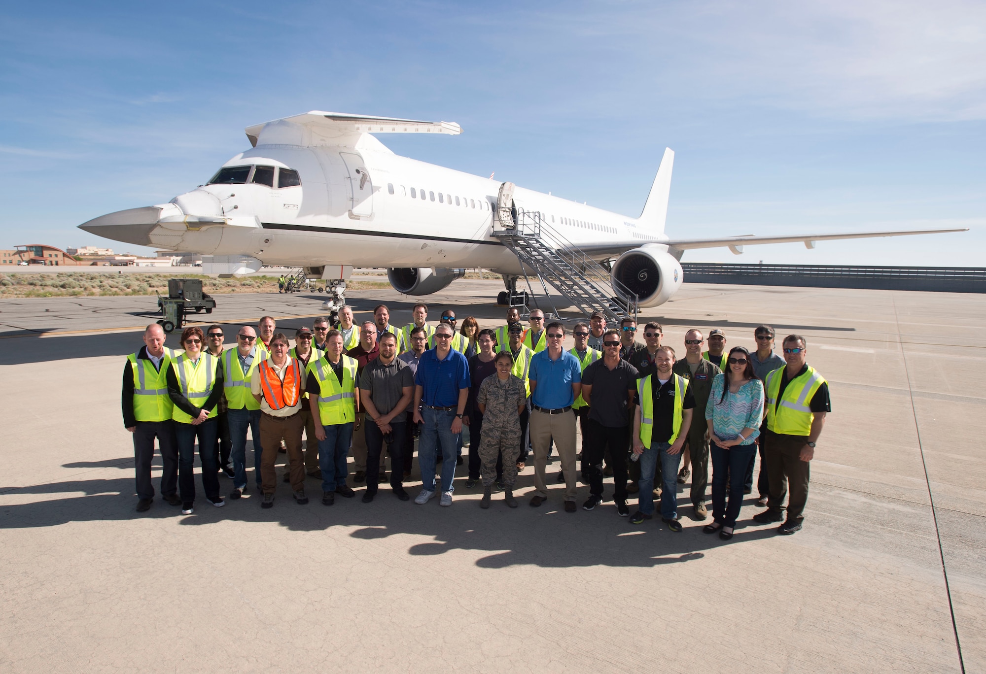 Members of the F-22 Flying Test Bed team pose for a photo in front of the highly modified Boeing 757 May 3. The FTB routinely flies with real Raptors both at Edwards and Nellis Air Force Base, Nevada in order to gain an early look at F-22 mission software before the software is released to developmental flight test, mainly at Edwards. The FTB can fly up to 30 crewmembers. (U.S. Air Force photo by Ethan Wagner)