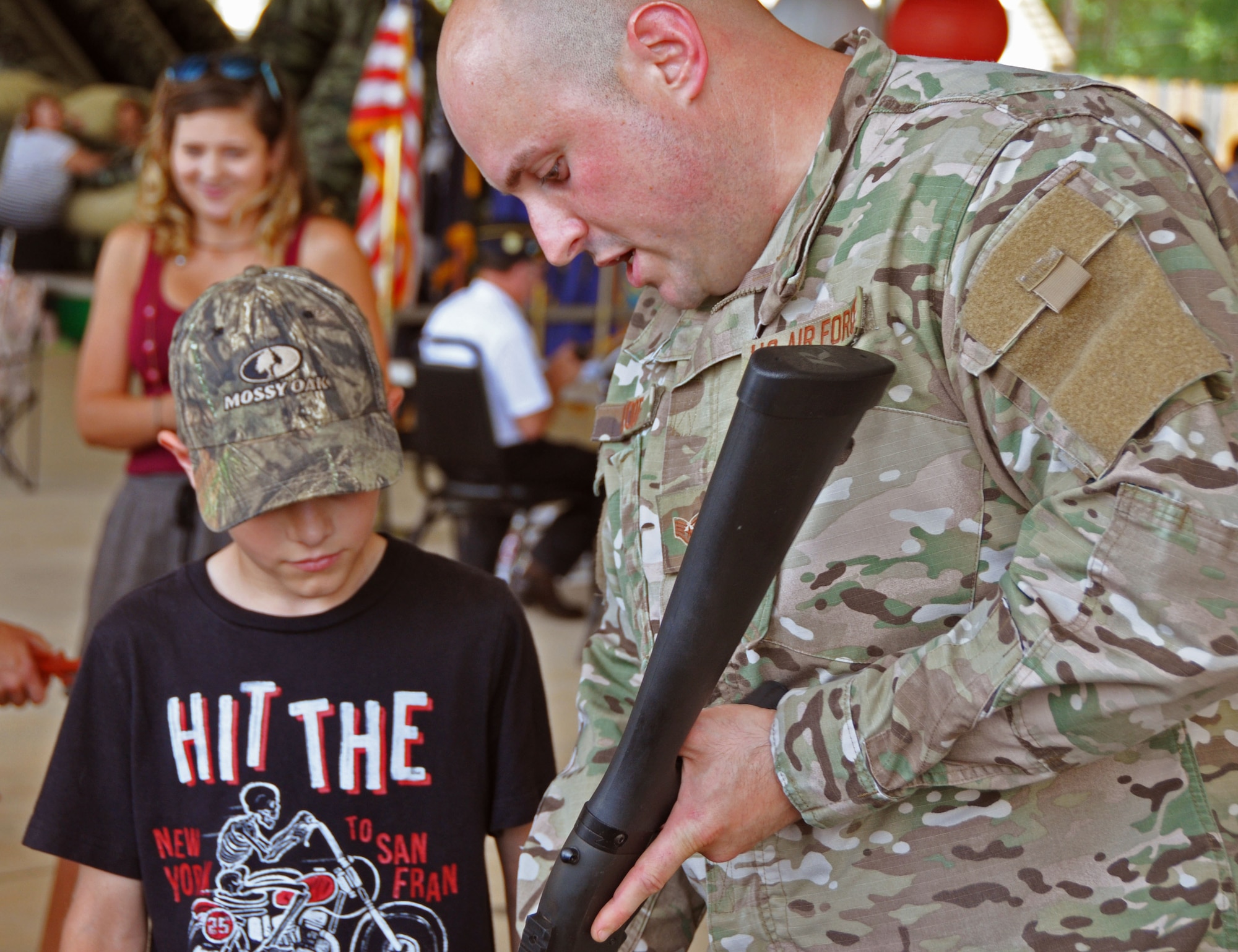 Staff Sgt. Brian Ploof, 919th Special Operations Security Forces Squadron, educates a young visitor about the M-870 shotgun at the Military Appreciation Recognition Celebration in Crestview, Fla., May 20, 2017. The annual event affords a unique opportunity for Crestview area citizens to meet military members and thank them for their service in national defense. (U.S. Air Force photo/Dan Neely)
