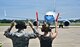 Airman 1st Class Zachary Keeven, 932nd Airlift Wing crew chief, assists Lauren Lauer with hand signals as she marshals in Maj. Jonathan Lauer on his fini flight May 22, 2017, Scott Air Force Base, Illinois.  Lauer, former executive officer for the 932nd Airlift Wing commander, took a new senior executive position with Air Mobility Command. (U.S. Air Force photo by Christopher Parr)