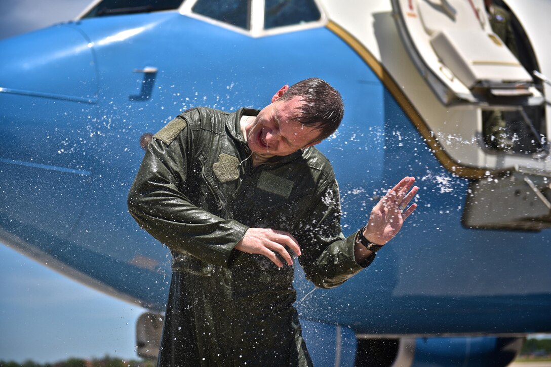 Maj. Jonathan Lauer, former executive officer for the 932nd Airlift Wing, dodges blasts of water during his fini flight ceremony May 22, 2017, Scott Air Force Base, Illinois. (U.S. Air Force photo by Christopher Parr)