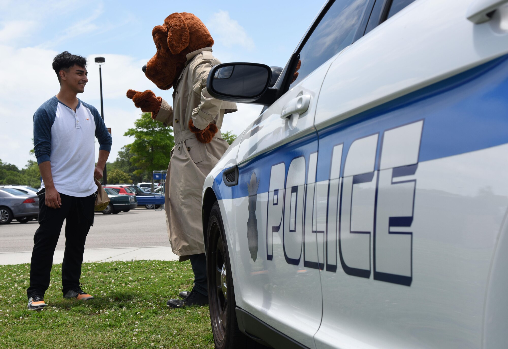 Airman 1st Class Devon Montoya, 81st Diagnostic and Therapeutic Squadron radiologic technician, talks with McGruff, the crime dog, during the 81st Security Forces Squadron Police Week fun day at the Base Exchange May 18, 2017, on Keesler Air Force Base, Miss. The event was held during National Police Week, which recognizes the service of law enforcement men and women who put their lives at risk every day. (U.S. Air Force photo by Kemberly Groue)