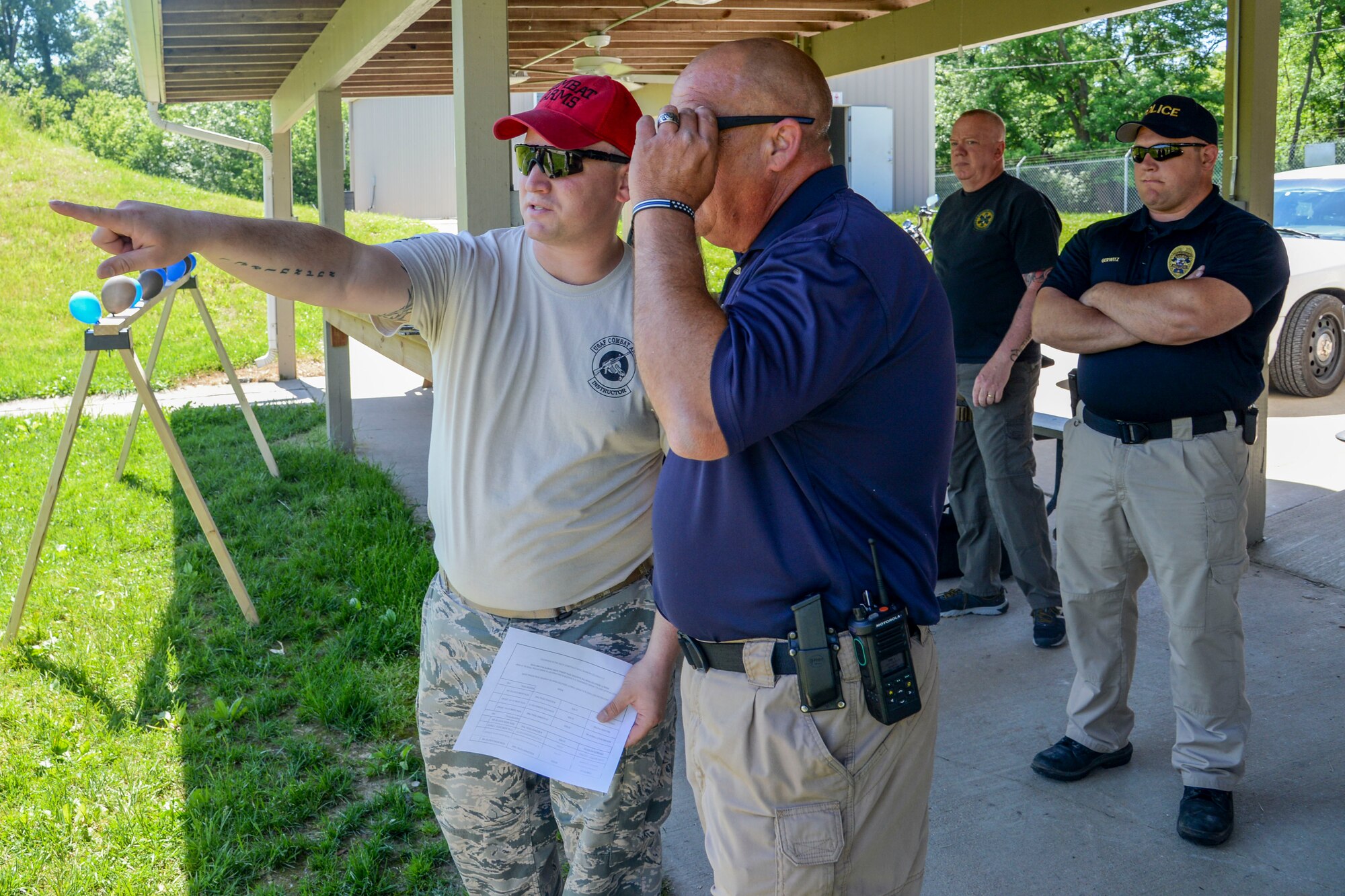 Staff Sgt. Nathan Minick, 375th, Security Forces Squadron, explains the rules and guidelines for the Police Week Shooting Competition to Craig Koch of the O’Fallon Police Department at the O’Fallon and Fairview Heights Police Department Range May 15, 2017. The rules and guidelines that were in place for the event made the course challenging while insuring the participants were safe. (U.S. Air Force photo by Airman Chad Gorecki)