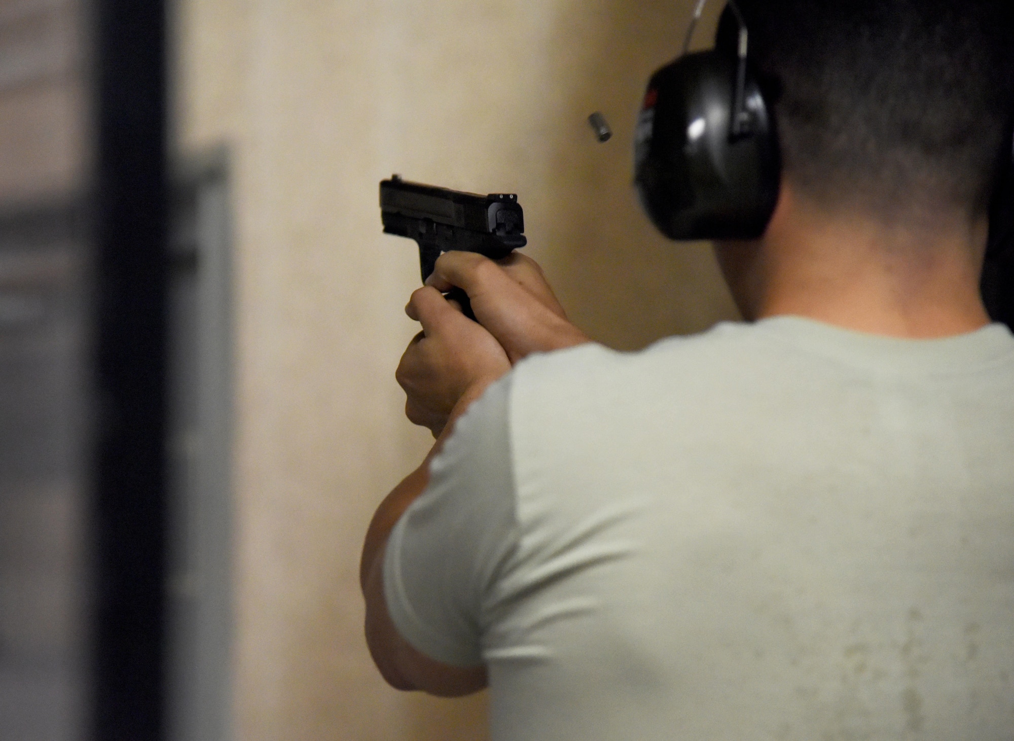 First Lt. Christian Torres, 2nd Air Force budget chief, fires his weapon during the 81st Security Forces Squadron open base pistol shoot at the indoor firing range May 15, 2017, on Keesler Air Force Base, Miss. The event was held during National Police Week, which recognizes the service of law enforcement men and women who put their lives at risk every day. (U.S. Air Force photo by Kemberly Groue)