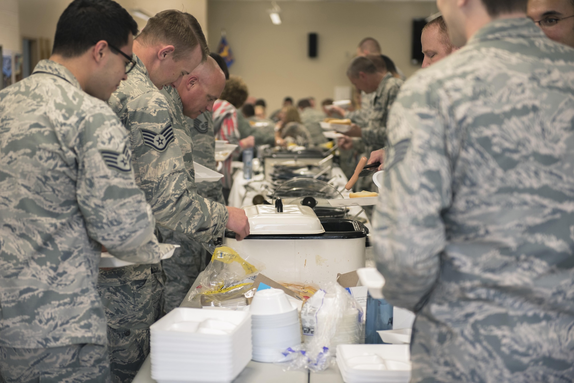Airmen with the 182nd Airlift Wing, Illinois Air National Guard, examine chilies at the wing’s ninth-annual chili cook-off in Peoria, Ill., May 17, 2017. Staff Sgt. Nicholas Freeman, an aerospace maintenance journeyman with the 182nd Aircraft Maintenance Squadron, Illinois Air National Guard, won first place in overall points, first place for consistency and tied for second place in the People’s Choice vote against 13 other chilies. (U.S. Air National Guard photo by Tech. Sgt. Lealan Buehrer)