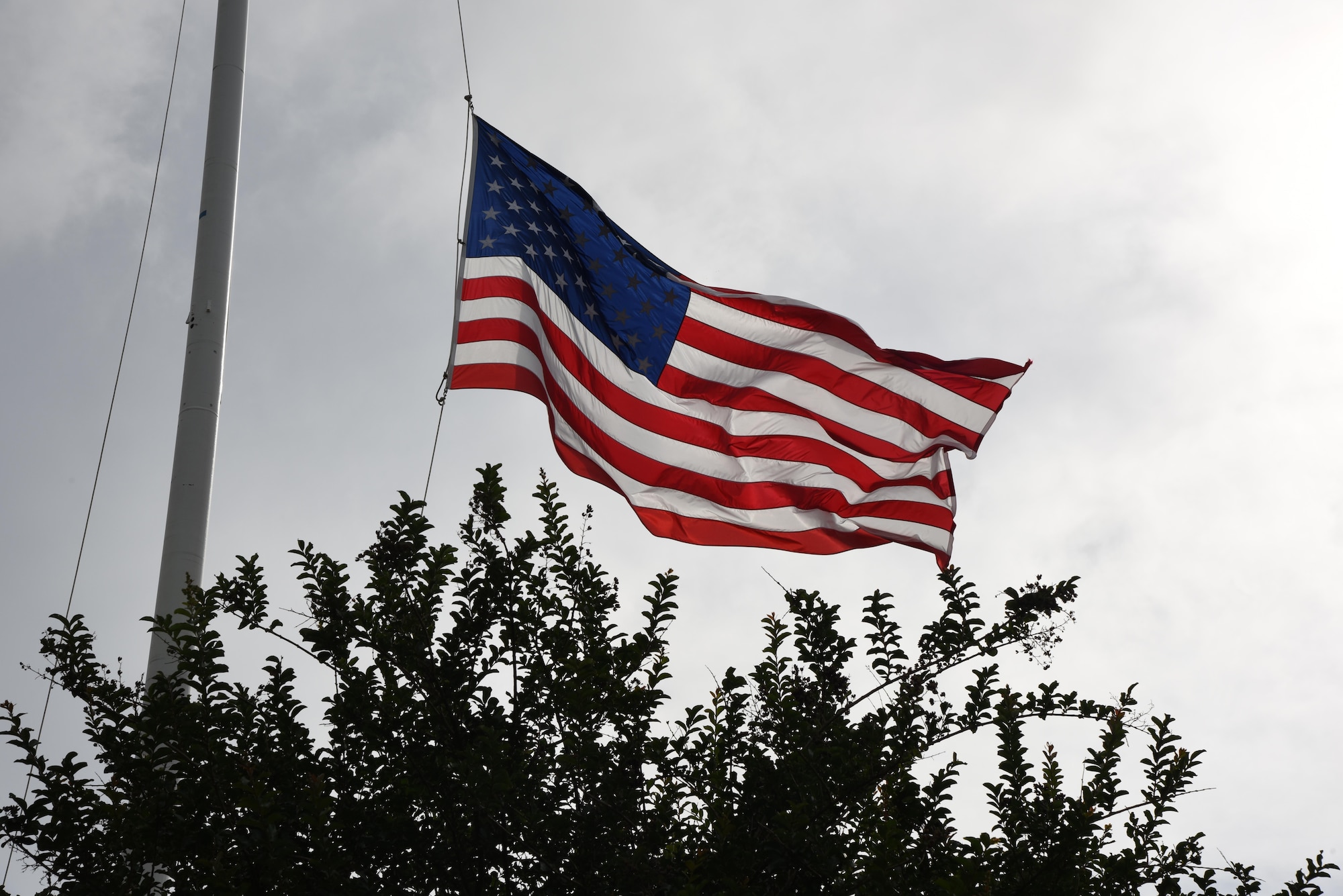 The U.S. Flag waves as it is lowered during the 81st Security Forces Squadron retreat ceremony May 18, 2017, on Keesler Air Force Base, Miss. The event was held during National Police Week, which recognizes the service of law enforcement men and women who put their lives at risk every day. (U.S. Air Force photo by Kemberly Groue)
