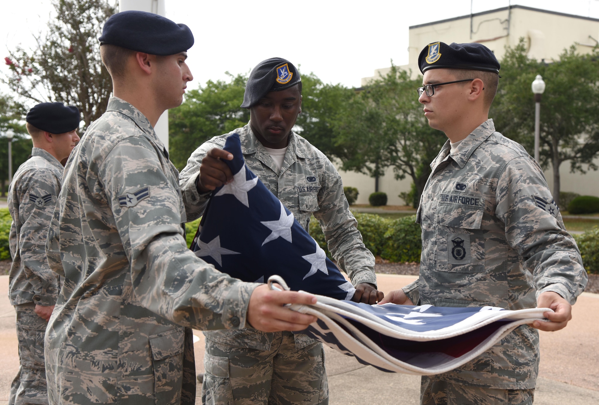 Members of the 81st Security Forces Squadron conduct a flag folding ceremony during the 81st SFS retreat ceremony May 18, 2017, on Keesler Air Force Base, Miss. The event was held during National Police Week, which recognizes the service of law enforcement men and women who put their lives at risk every day. (U.S. Air Force photo by Kemberly Groue)
