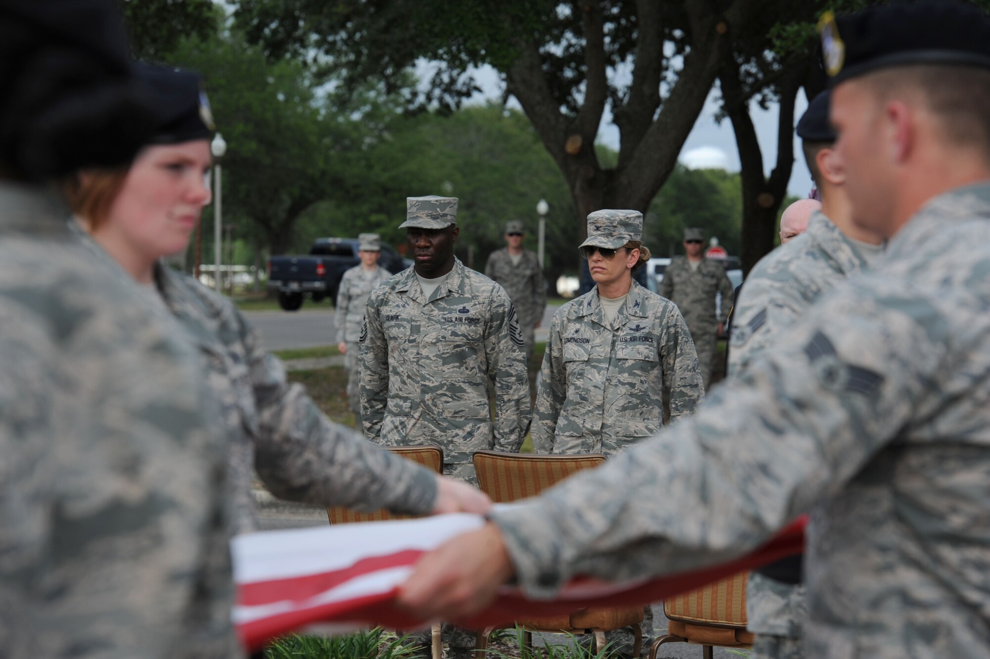 Col. Michele Edmondson, 81st Training Wing commander, and Chief Master Sgt. Vegas Clark, 81st TRW command chief, stand at attention during the 81st Security Forces Squadron retreat ceremony May 18, 2017, on Keesler Air Force Base, Miss. The event was held during National Police Week, which recognizes the service of law enforcement men and women who put their lives at risk every day. (U.S. Air Force photo by Kemberly Groue)