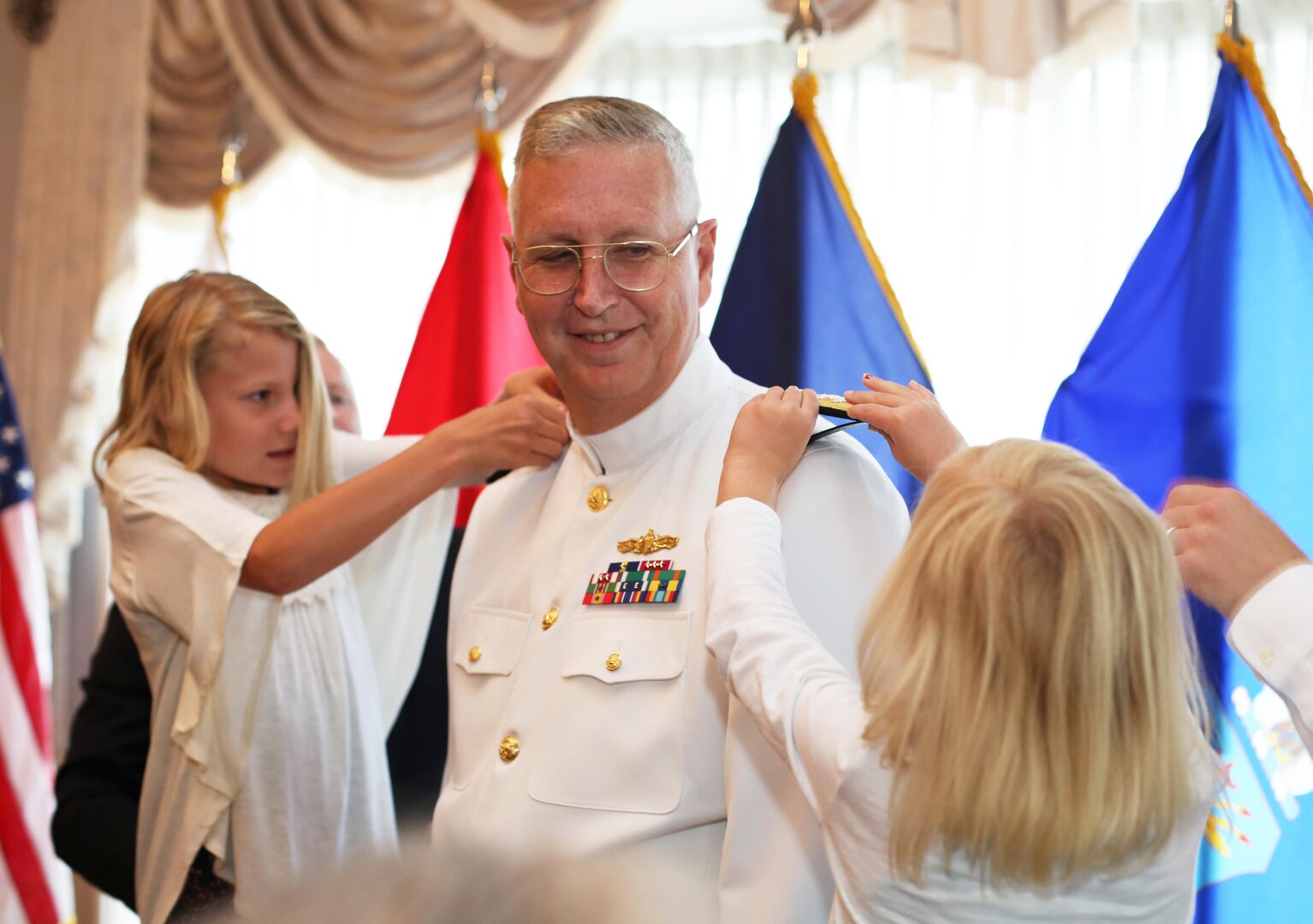 Navy Vice Adm. David H. Lewis, with the assistance of his granddaughters, pins on a third star during his promotion ceremony at Fort Lee, Virginia, May 24. Later that morning Lewis assumed command of the Defense Contract Management Agency. (DCMA photo by Stephen Hickok)