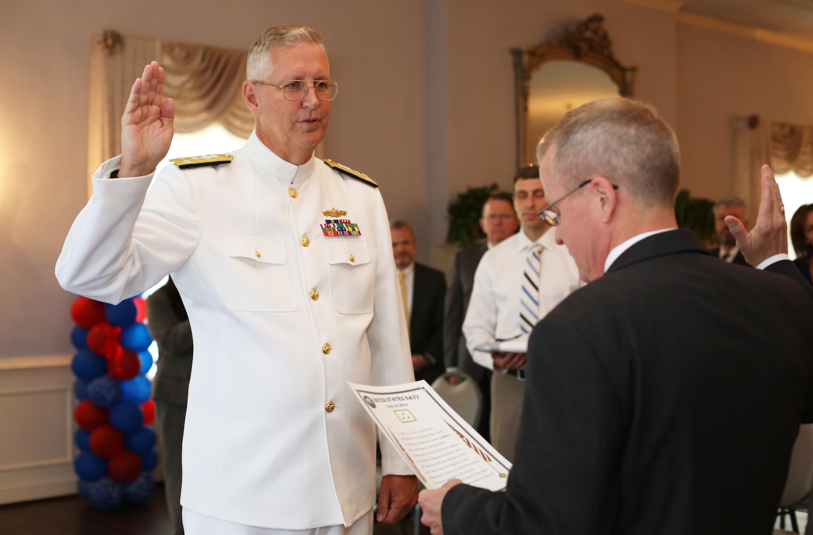 Navy Vice Adm. David H. Lewis reaffirms his oath during his promotion ceremony at Fort Lee, Virginia, May 24. Later that day, Lewis assumed command of the Defense Contract Management Agency. James MacStravic, performing the duties of undersecretary of defense for acquisition, technology and logistics, officiated both ceremonies. (DCMA photo by Stephen Hickok)