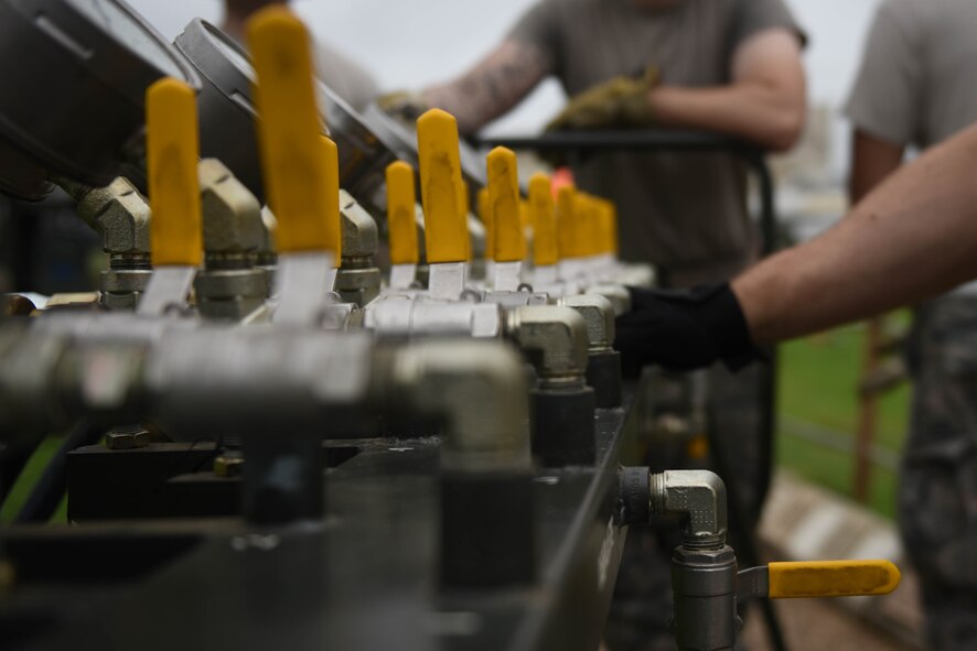 Airmen from 2nd Maintenance Group use an air manifold during an aircraft lift at Barksdale Air Force Base, La., May 23, 2017. An air manifold is used to fill bags with air which raise the static aircraft off the ground. (U.S. Air Force photo/Airman 1st Class Stuart Bright)