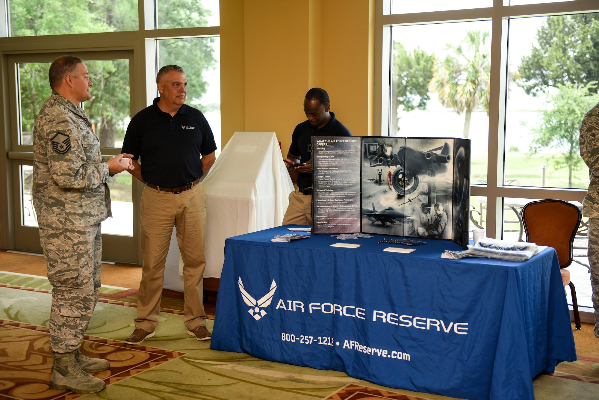 Master Sgts. John Fusco, left, and Michael Perkins, in-service recruiters assigned to the 1st Special Operations Force Support Squadron, wait to meet with potential candidates during the 2017 Career Symposium at the Soundside Club, Hurlburt Field, Fla., May 24, 2017. In-service recruiters provide Airmen separating from active duty with information on opportunities and benefits offered in the Air Force Reserves. (U.S. Air Force photo by Staff Sgt. Jeff Parkinson)