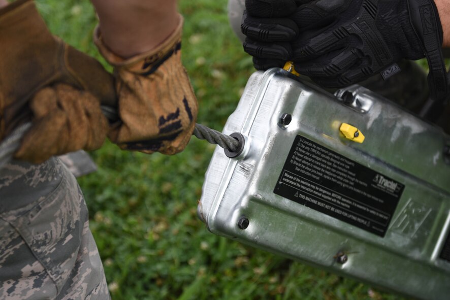 Airmen prepare to anchor static SR-71 Blackbird before it is lifted at Barksdale Air Force Base, La. May 23, 2017. The aircraft was anchored to secure it during the lift.(U.S. Air Force photo/Airman 1st Class Stuart Bright)