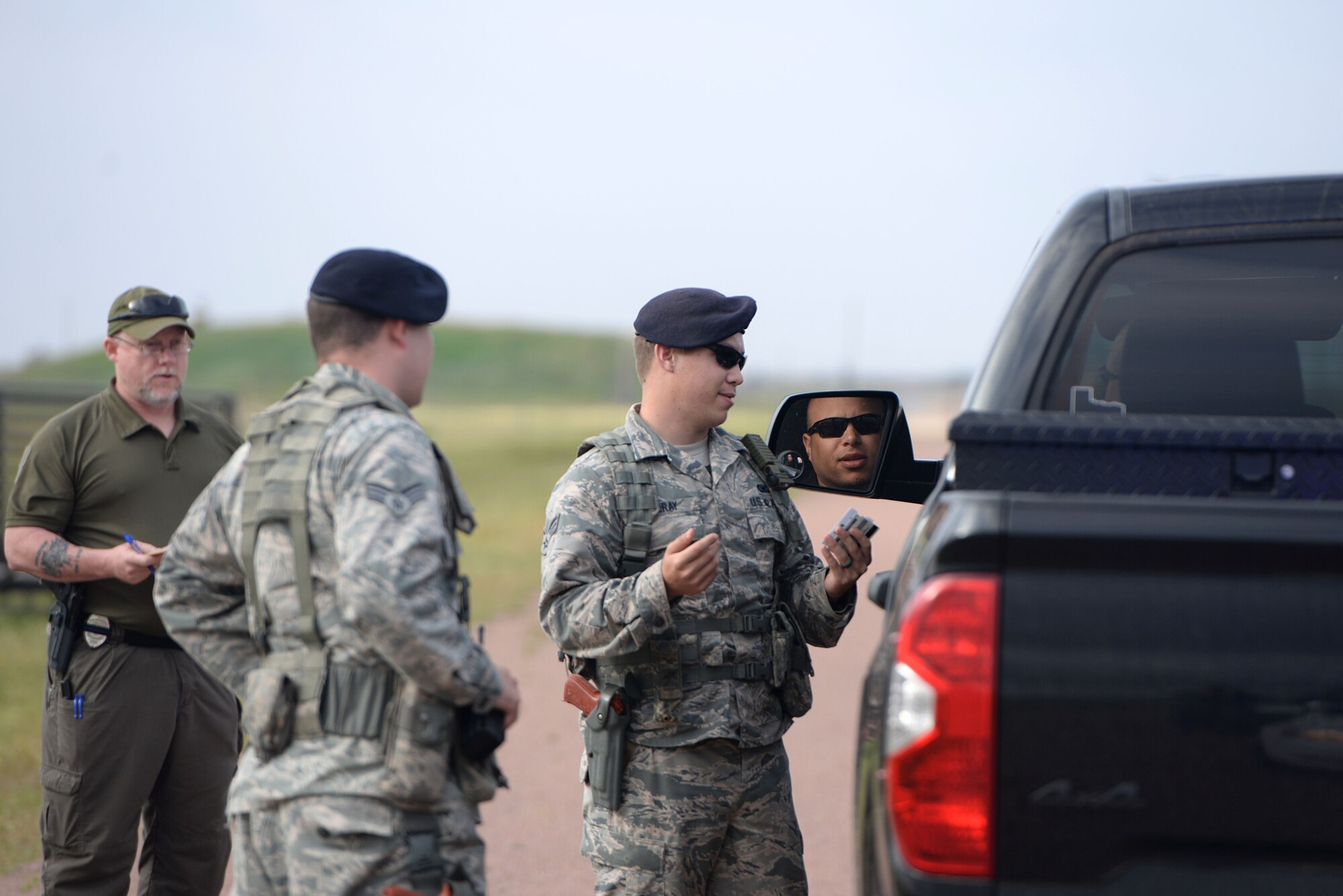 U.S. Air Force Senior Airman Taylor Murray, 97th Security Forces flight sergeant, and U.S. Air Force Senior Airman Josh Krois, 97th SFS response force leader, pull over Abraham Velez, 97th SFS investigator, for a simulated failed complete stop during the Defenders Challenge, May 18, 2017, at Altus Air Force Base, Oklahoma. This is the 10th year that Altus AFB has hosted events to celebrate Police Week, honoring those who have lost their lives in the line of duty. (U.S. Air Force photo by Airman 1st Class Cody Dowell/released)