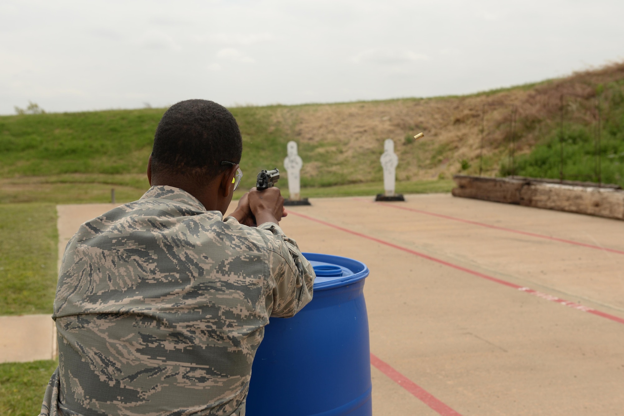 U.S. Air Force Master Sgt. Roderick Hill, 97th Security Forces Squadron first sergeant, takes aim at targets during the Altus Police Department shoot out, May 23, 2017, at Altus, Oklahoma. This is the 10th year that Altus AFB has hosted events to celebrate Police Week, honoring those who have lost their lives in the line of duty. (U.S. Air Force photo by Airman 1st Class Cody Dowell/released)