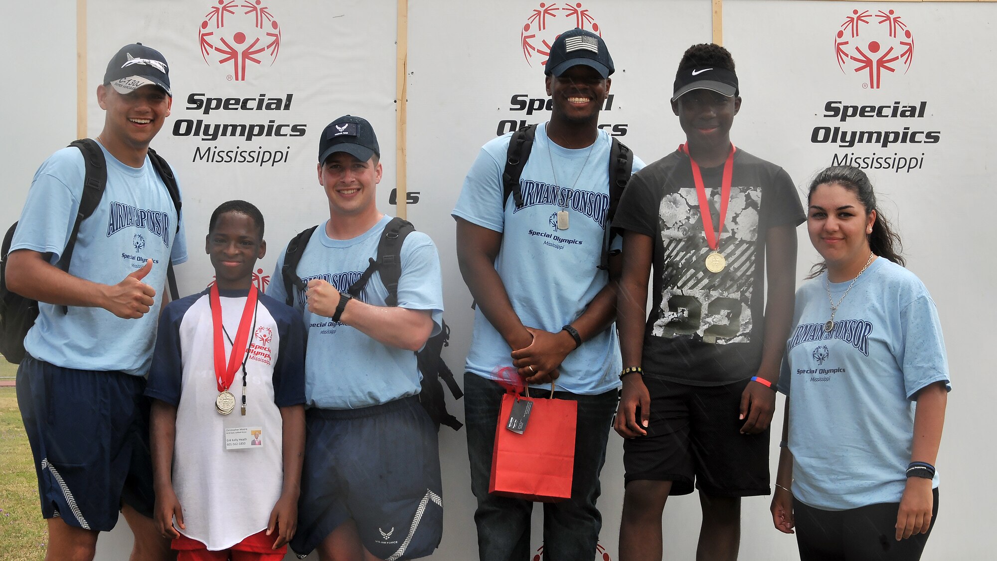 Airmen sponsors and athletes pause for a photo during the Special Olympics Mississippi 2017 Summer Games May 20, 2017, on Keesler Air Force Base, Miss. Keesler hosted more than 3,200 athletes, directors, coaches, family members and volunteers spanning over 16 regions across Mississippi for the 31st year. (U.S. Air Force photo by Senior Airman Jenay Randolph)
