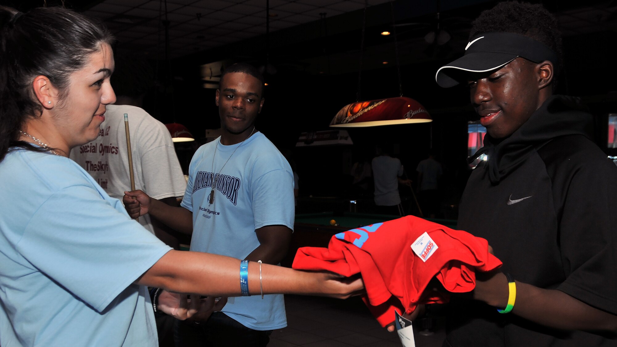 Airman 1st Class Sierra Ward, 335th Training Squadron student, gives Nicholas Berry, Special Olympics athlete, some Air Force memorabilia during the Special Olympics Mississippi 2017 Summer Games May 20, 2017, on Keesler Air Force Base, Miss. Berry’s Airman sponsors got him the souvenirs to remember his first time competing at the state games on base. (U.S. Air Force photo by Senior Airman Jenay Randolph) 